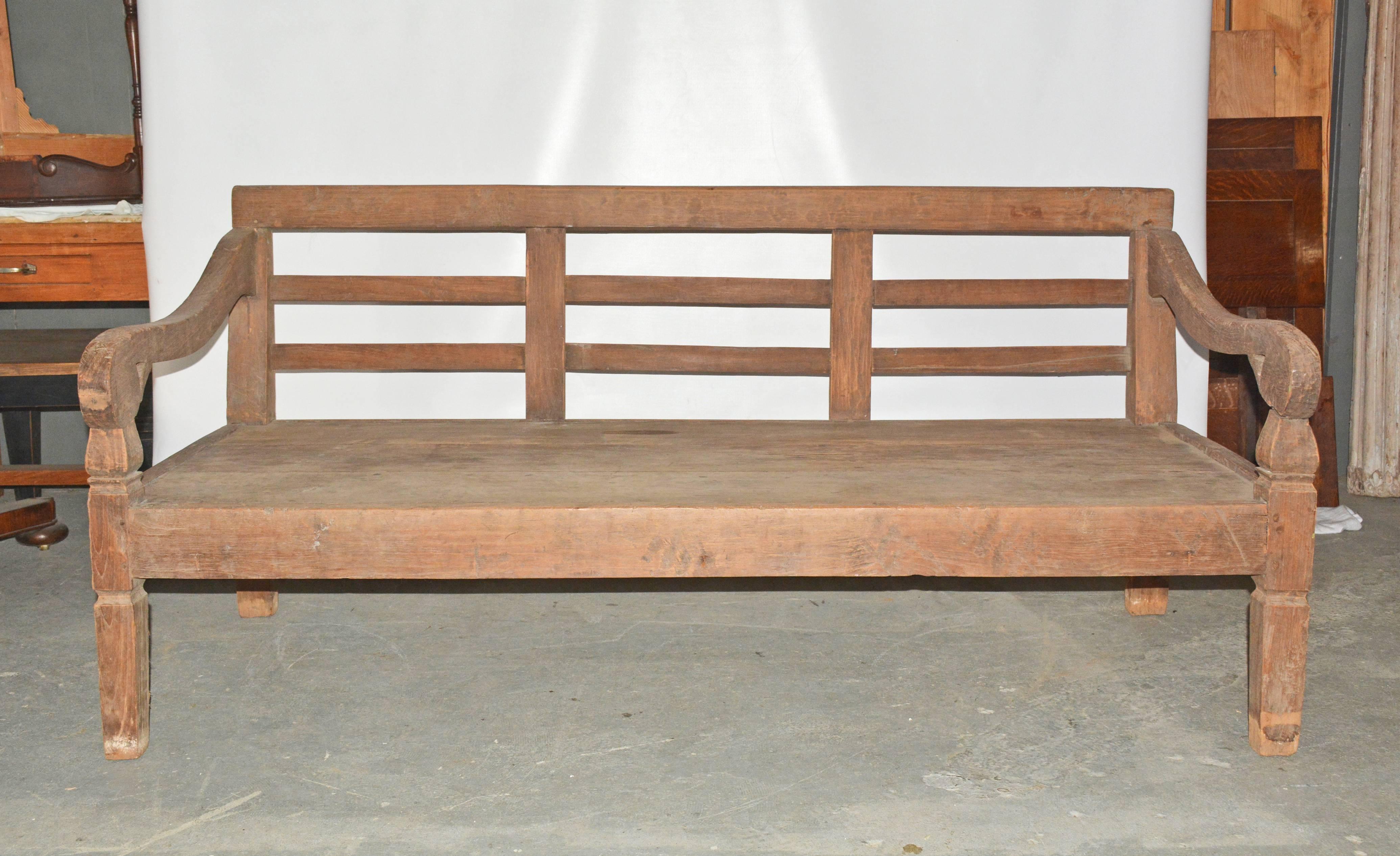 Colonial influenced antique hand-carved rustic country daybed or bench made from natural aged teak, deep enough for sleeping or relaxing. Suitable for indoor or outdoor use. Great on a porch or patio.
Measures: Arm height: 25.75".