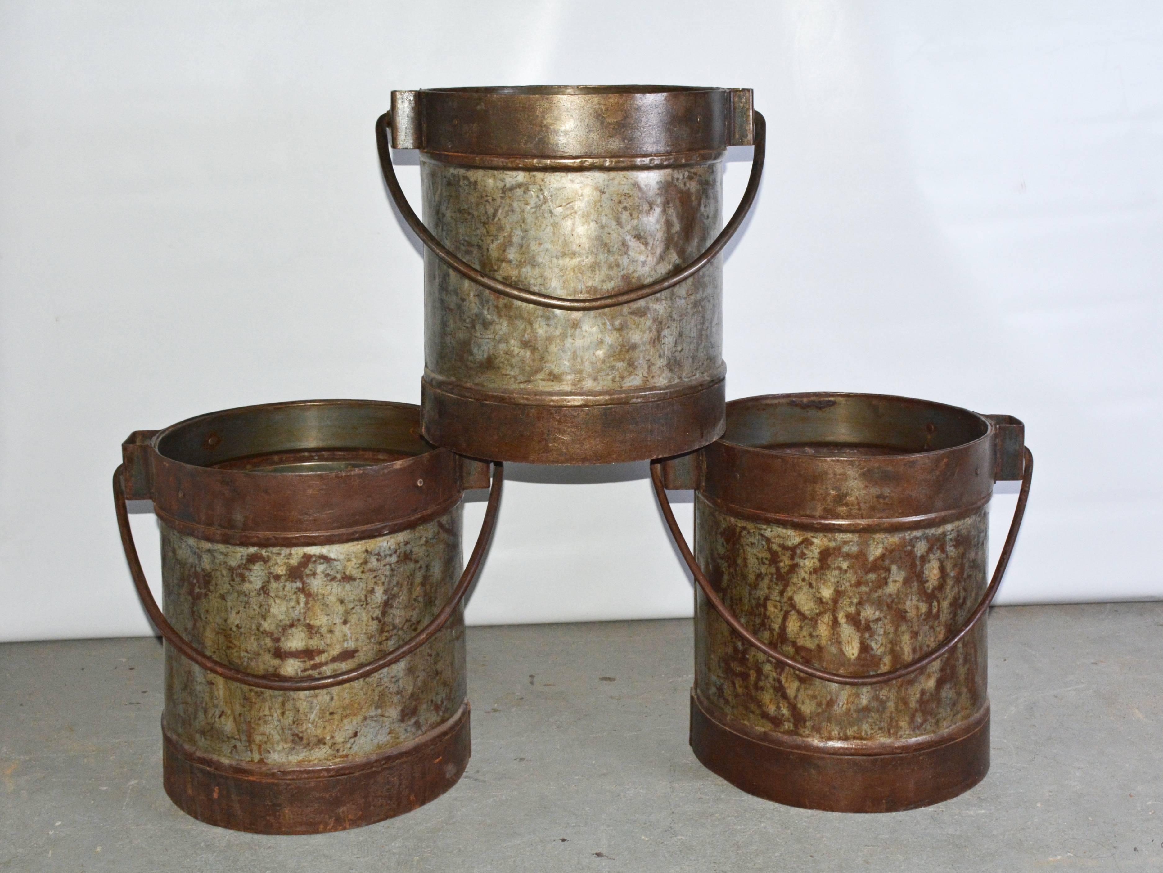 Wonderful antique Industrial iron metal bucket can be used for logs, kindling, fireplace tools or put a piece of glass, wood or stone on top and use as a side or end table.  Two matching buckets are available.  Price is for one bucket.
Measures: