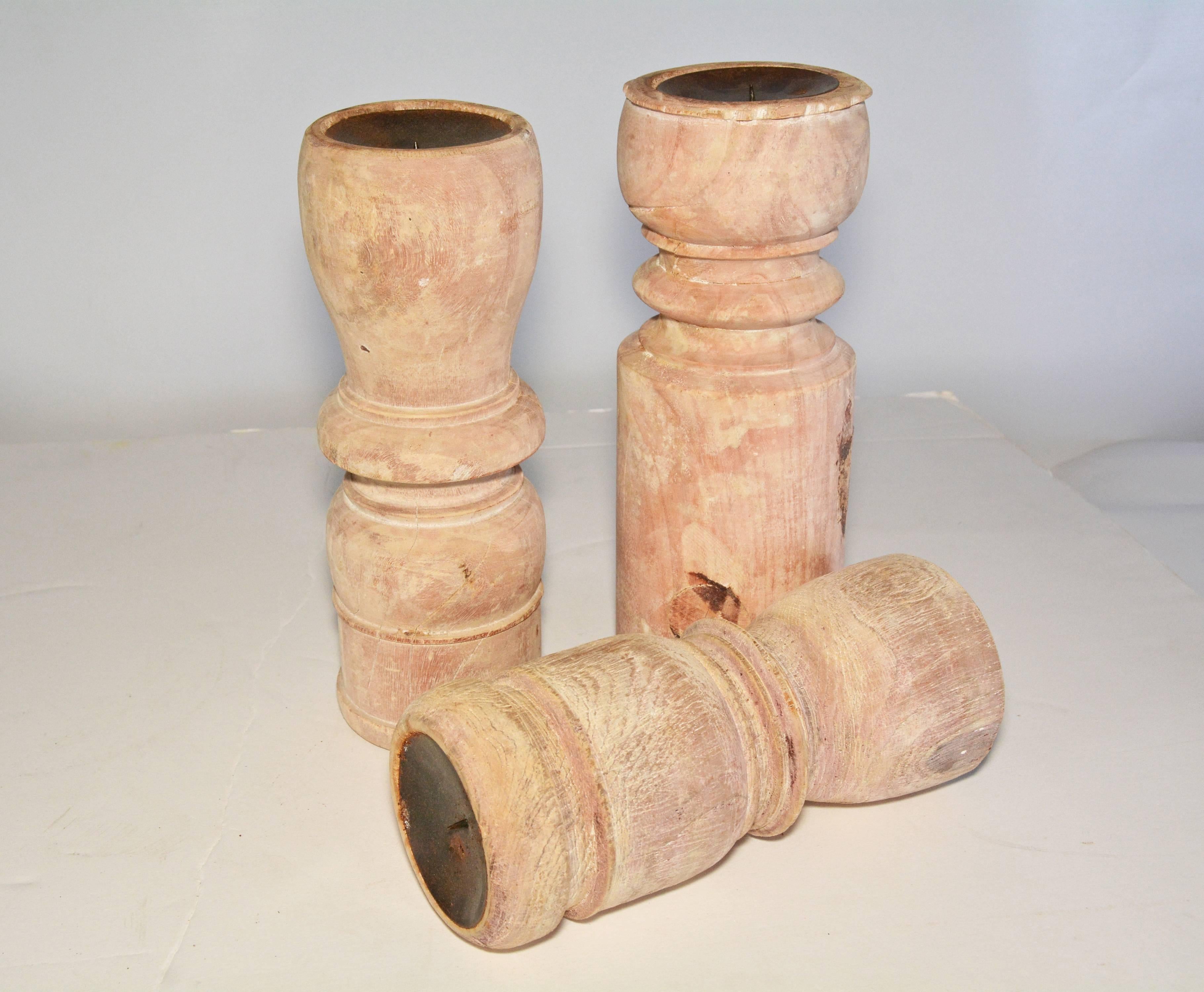The rustic teak candlesticks of three varying heights have concave tops lined in metal with center spikes to hold flat pillar candles. Made from reclaimed antique architectural elements. Each one is unique.
Measures: Diameter 3.75