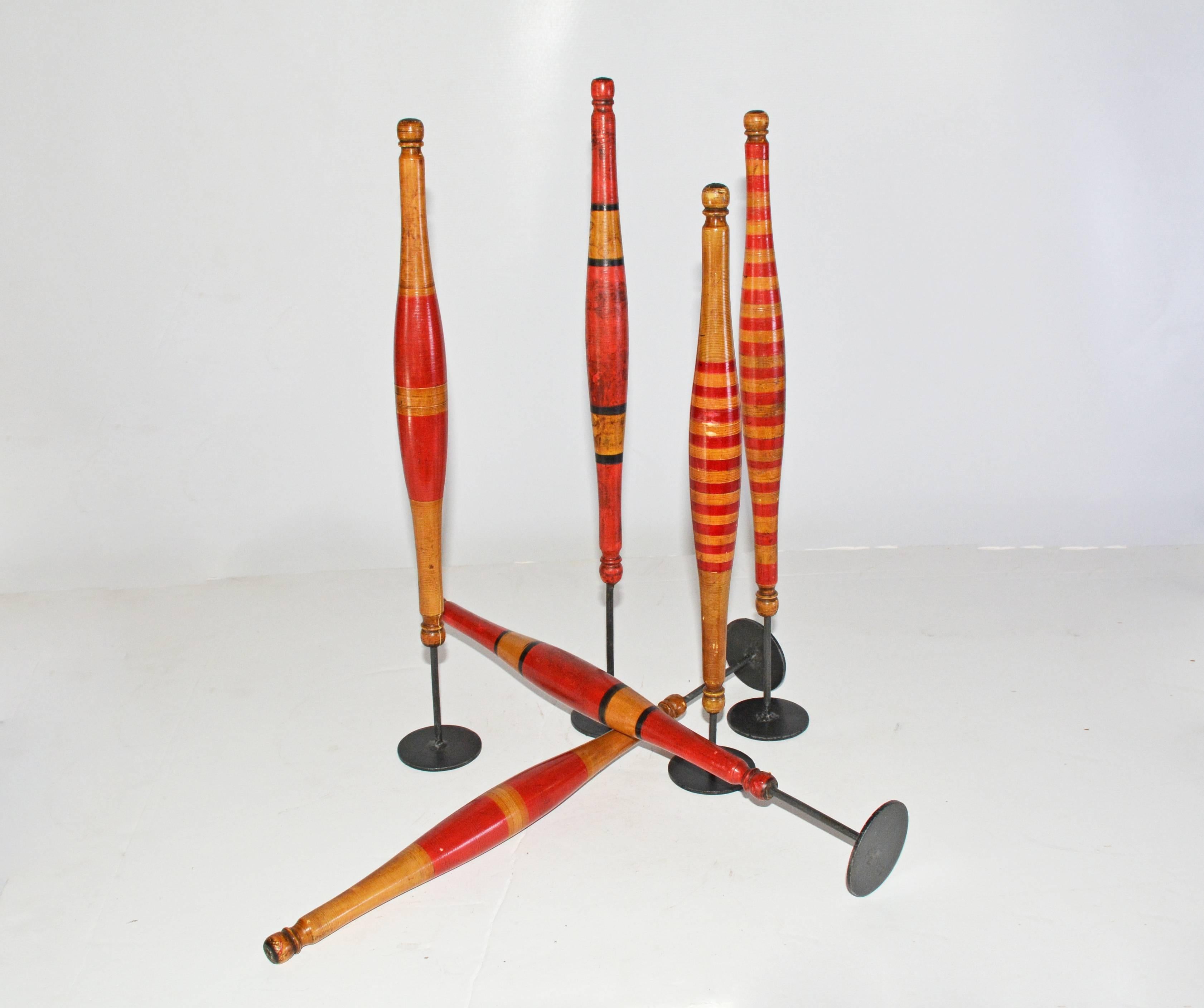 Grouping of six colorful decorative vintage wood spindles are attached to iron stands and are painted in three different patterns. Great as sculptural display.

Measures: Height: 15.13