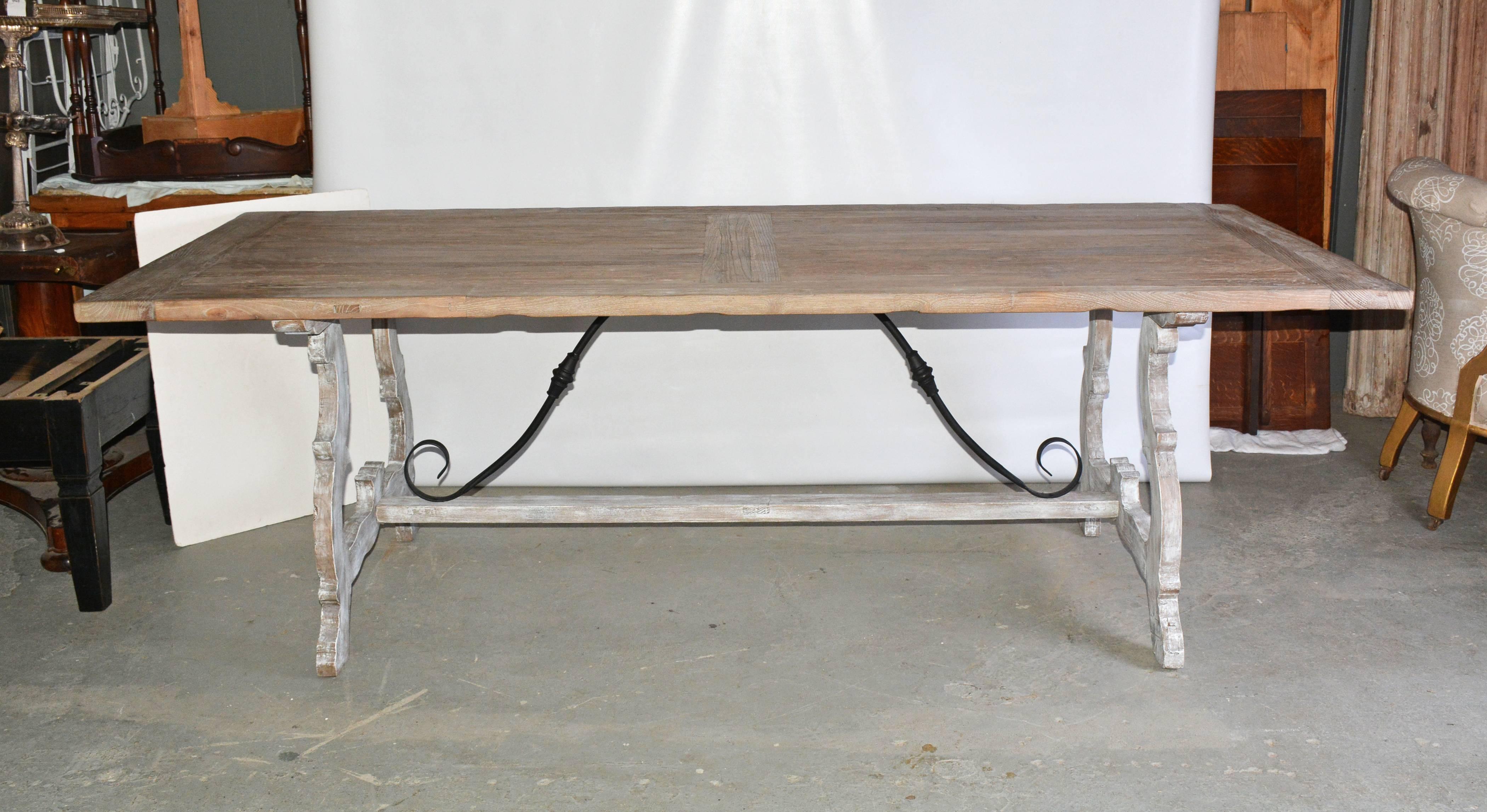 Can be Mediterranean Tuscan Italian or Spanish Renaissance style refectory dining table. Combines a elmwood top with breadboard ends and a Baroque-style oak and wrought iron base. Seats up to ten diners.