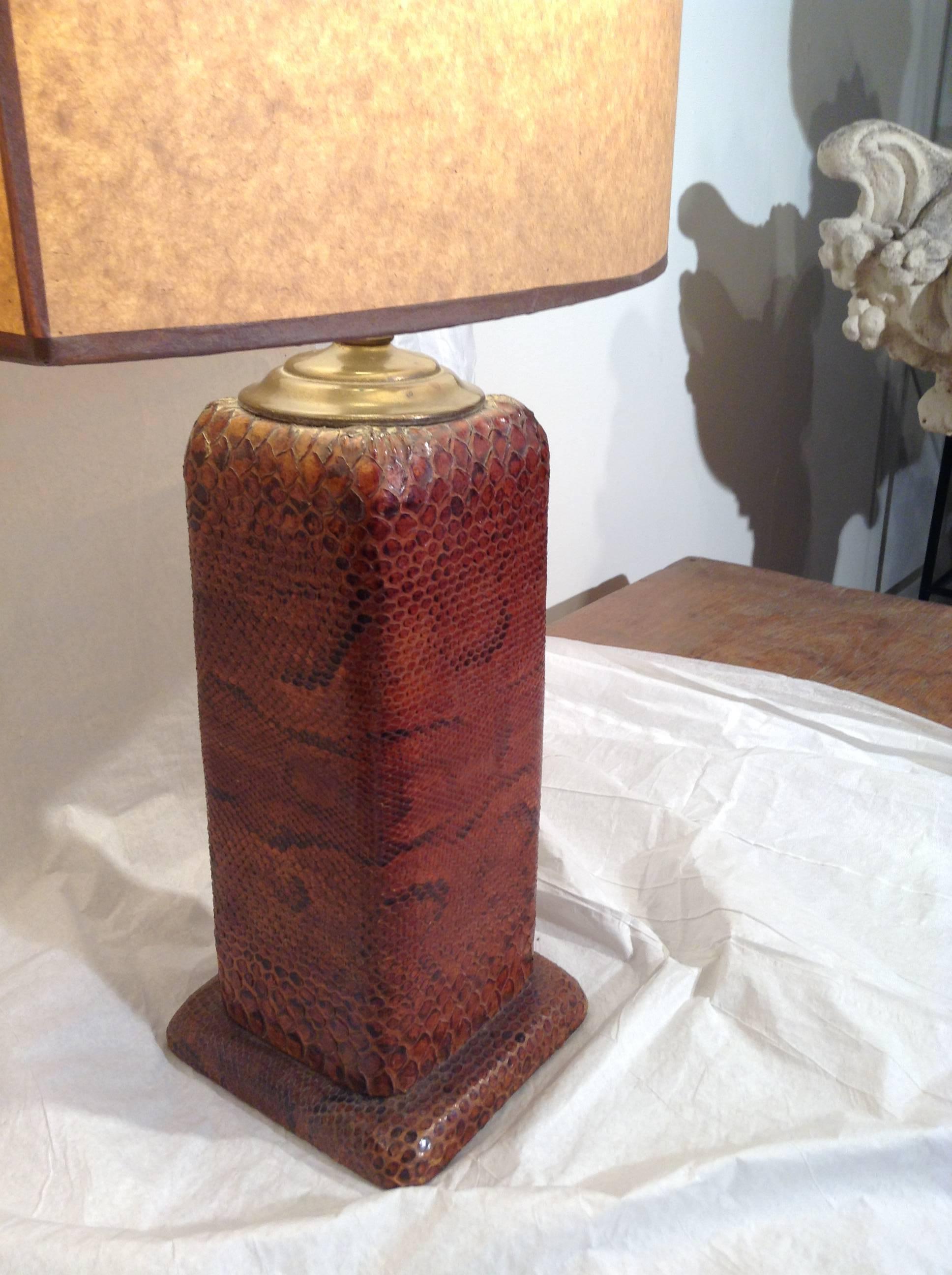 Early 20th century python skin lamps hand stretched snake skin on solid bases. Handmade parchment lampshades.