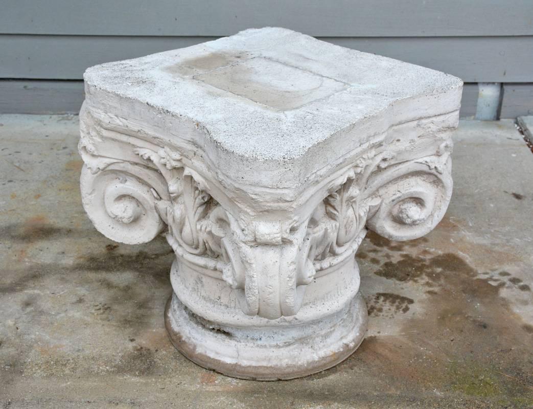 The ionic cast stone cement pedestal has the classic curls at all four corners based on the ancient Greek inspiration of ram's horns. Leaves embellish the design as well. Makes a great low garden, patio, porch side table or base.