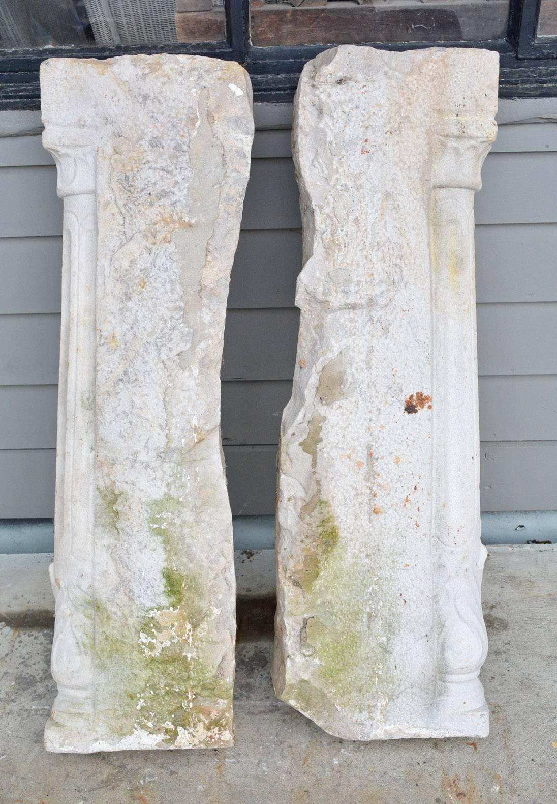 The pair of antique stone console table supports or pedestals have finely carved fluted fronts topped by acanthus leaves set against uncarved backings. 

 