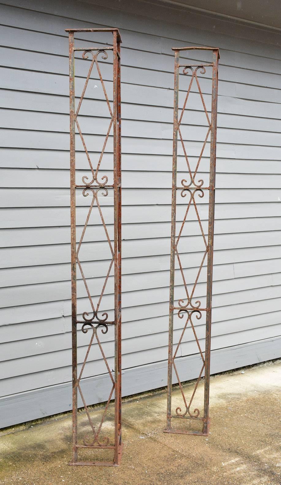 The pair of antique neoclassical wrought iron porch posts or porch supports define corners of the space, as well as act as supporting elements. Holes top and bottom for screws secure the brackets to the floor and ceiling.
They would also work well