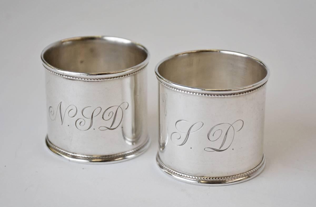 The pair of antique English napkin rings have bands of beading and are marked 