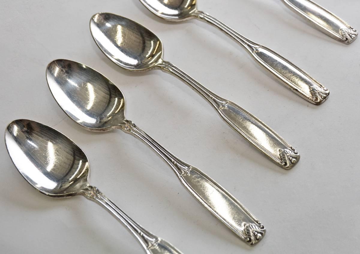 Las cucharillas de plata de hotel de época están decoradas con hojas y llevan la marca 