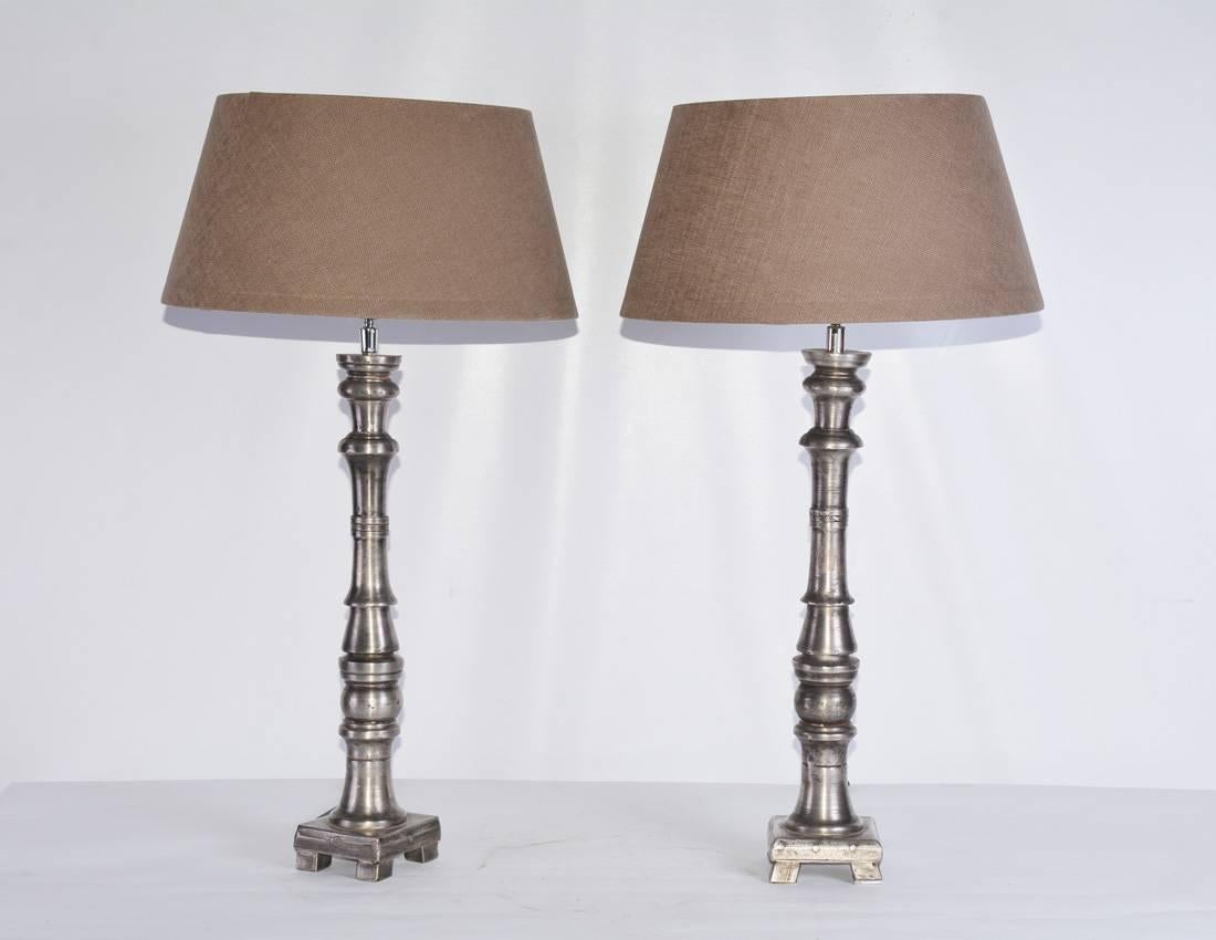 Pair of elegant neoclassical style lamps with cylindrical silvered metal base and hand made tan Belgium linen lamp shades.

Height to the top of the shade = 28