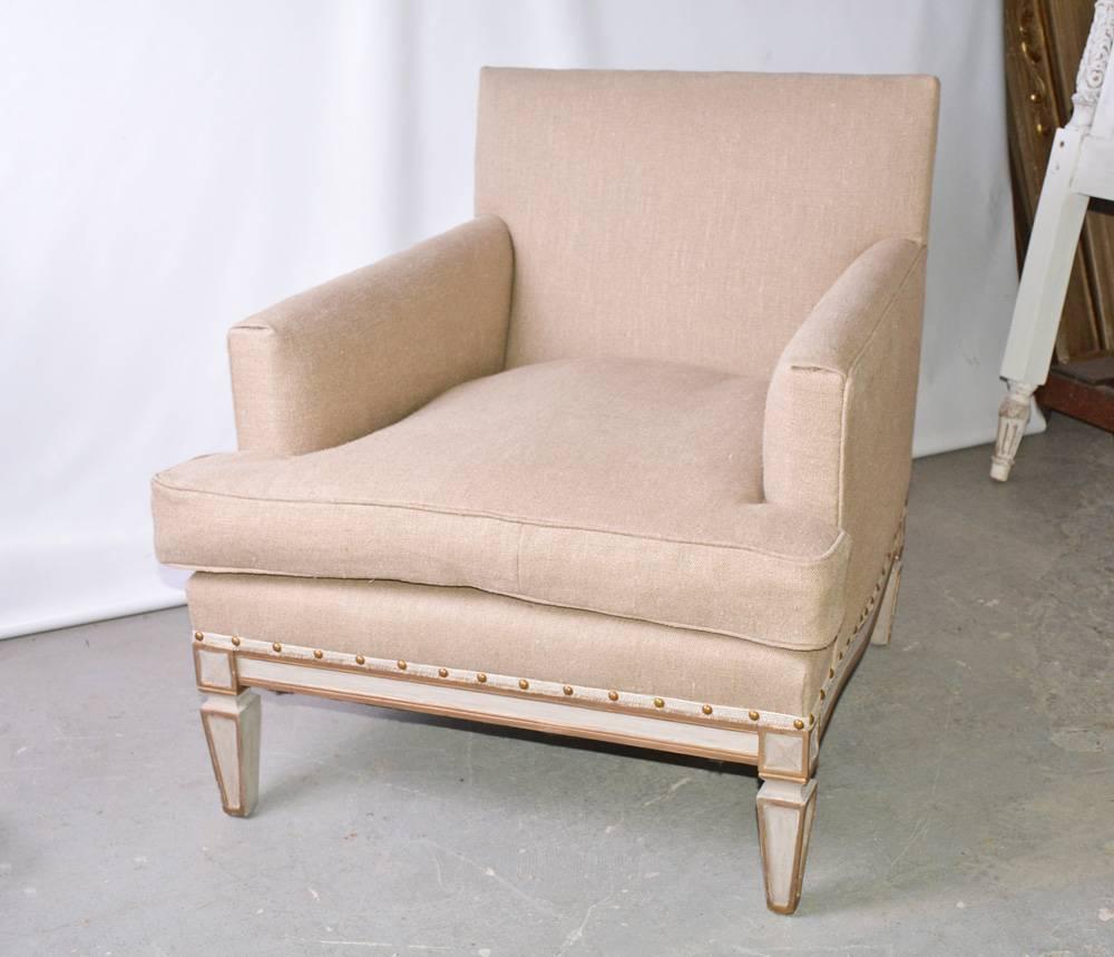 The vintage neoclassical armchair is newly upholstered in beige linen and has paneled legs and frame painted gold and white. Brass nailheads secure the upholstery. The seat is extra deep.
Can be used in Louis XVI, Directoire or Gustavian