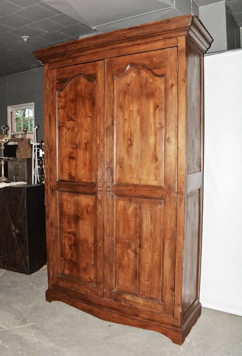 Louis XV armoire in the simple rustic style from Provence with interior storage shelving and four lower drawers.