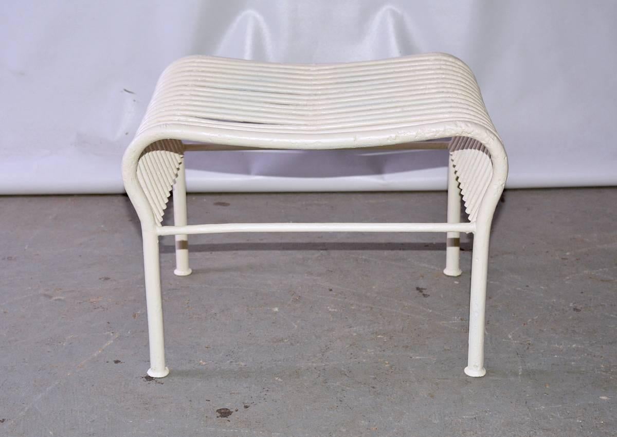 The outdoor stool is sturdy and made of tubular iron soldered together and painted.