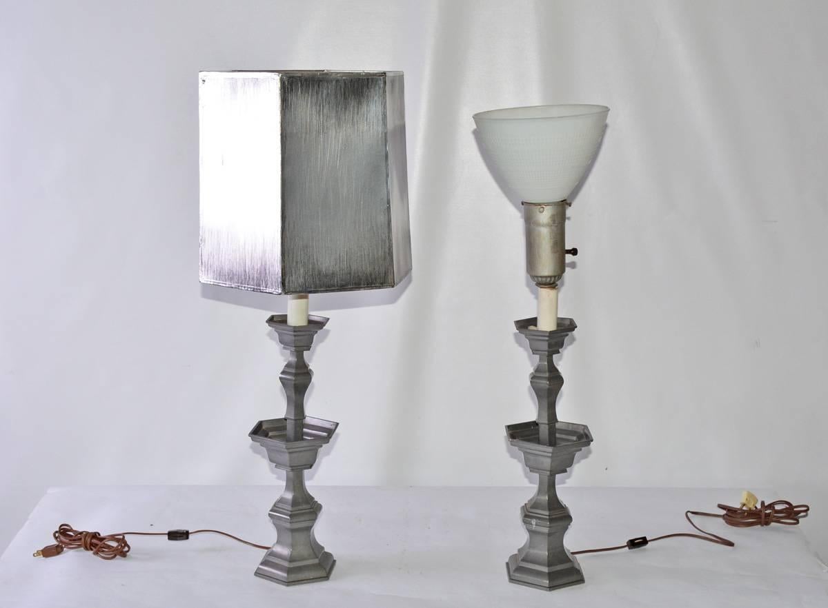 The pair of vintage pewter candlesticks table lamps and hexagonal shades with a brushed silver finish. The lamps are wired for US use and single bulbs. 

Measures: Height to glass bowl 29