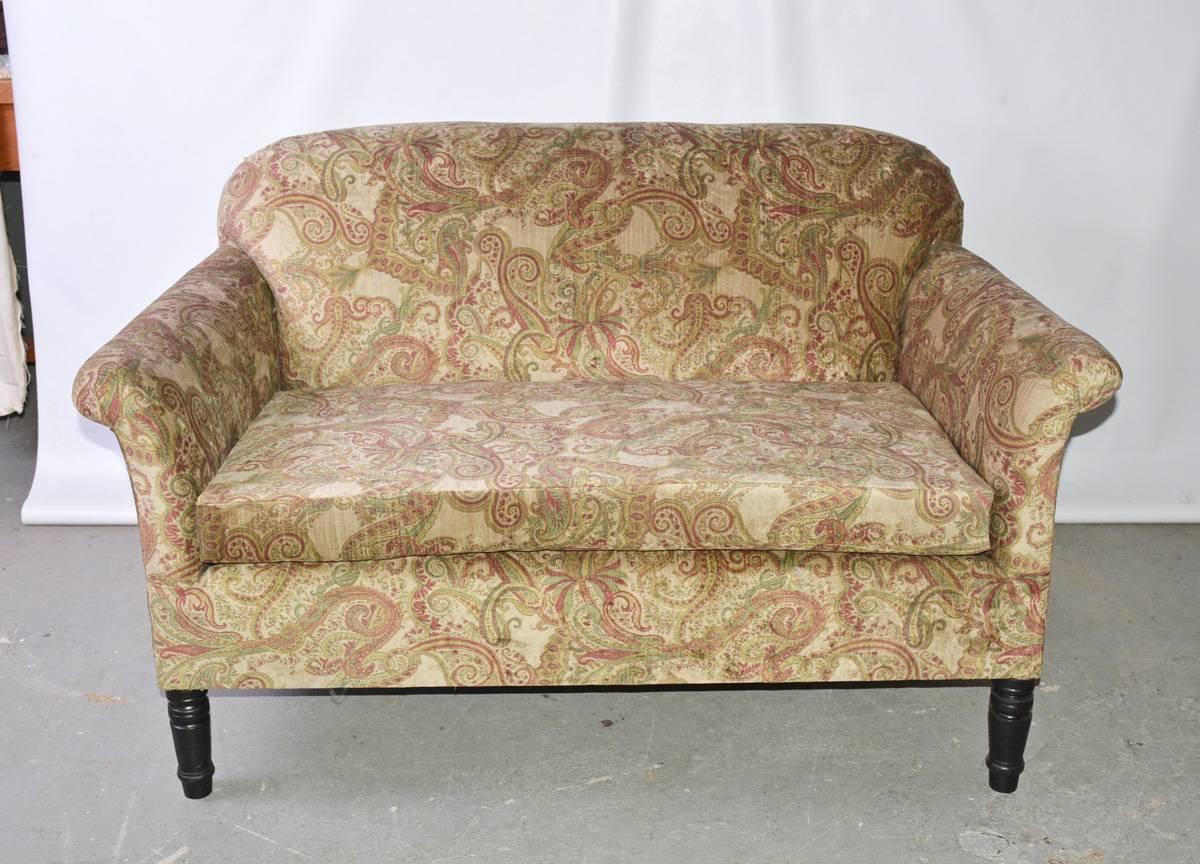 The vintage French Napoleon III-style loveseat sofa is newly covered in cotton velvet, the pattern of which is a green and red paisley. The legs are stained black wood and the front ones are turned.

Arm height: 24.50