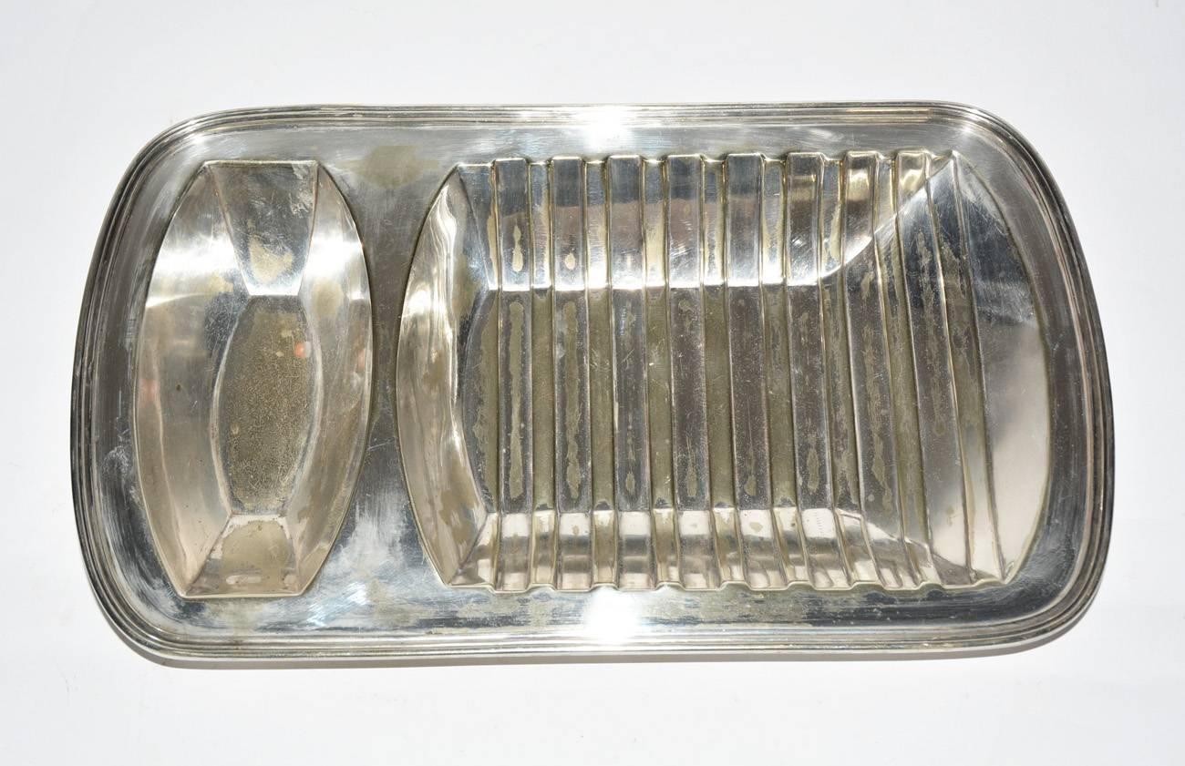 The vintage English serving dish has two cavities for food and is made of silver on copper. Stamped on the bottom with 
