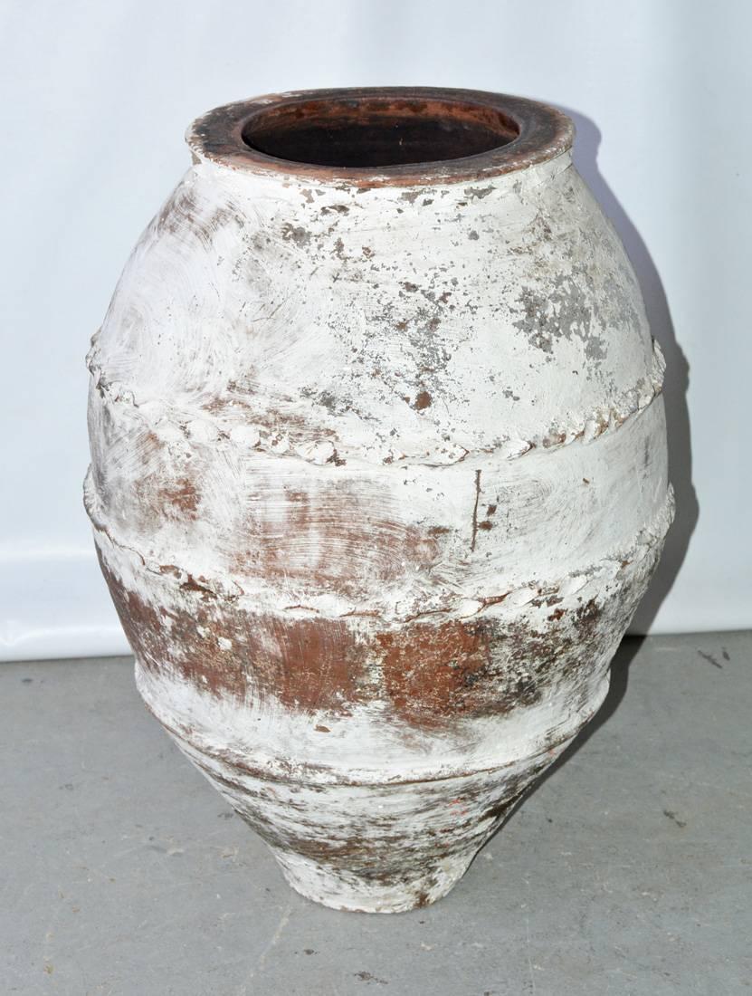 Large handcrafted terra cotta Mediterranean olive jar with raised bands, that has been white-washed with weathered, patinated surface.