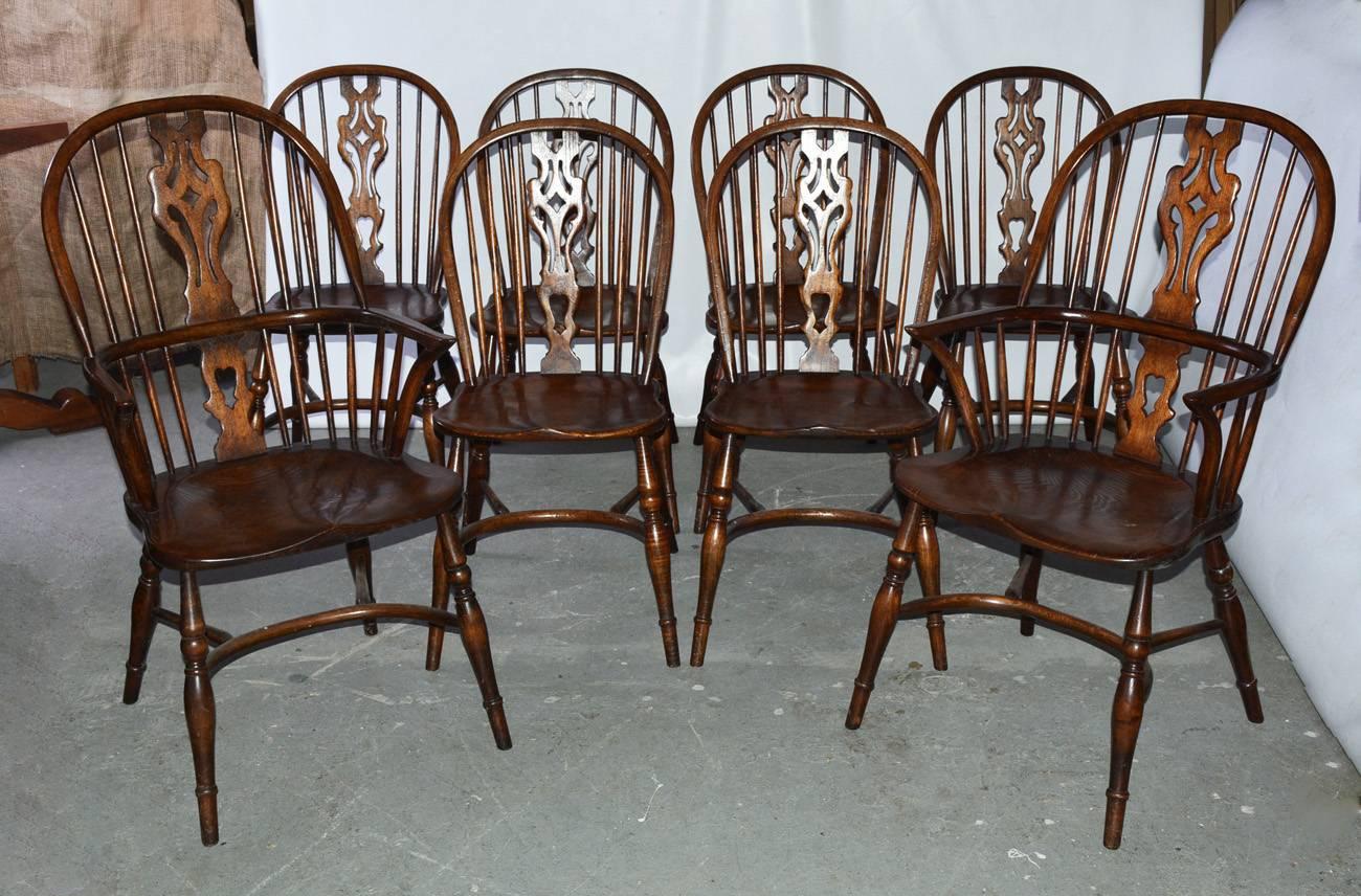 Set of eight Georgian style windsor dining chairs. Handcrafted, wonderful patina. The set is not identical. There are some difference in size and the size of pierced splat decoration on chair backs. Please see photos to see differences. Set includes