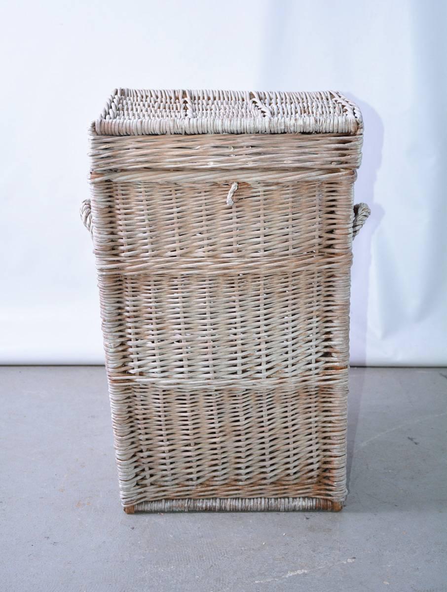 Early 20th century handwoven rustic white washed wicker or rattan laundry hamper or storage basket wi Tall with a lid and carrying handles, a very strong and stylish basket is perfect to fit in a bathroom, kitchen or mud room or any other practical