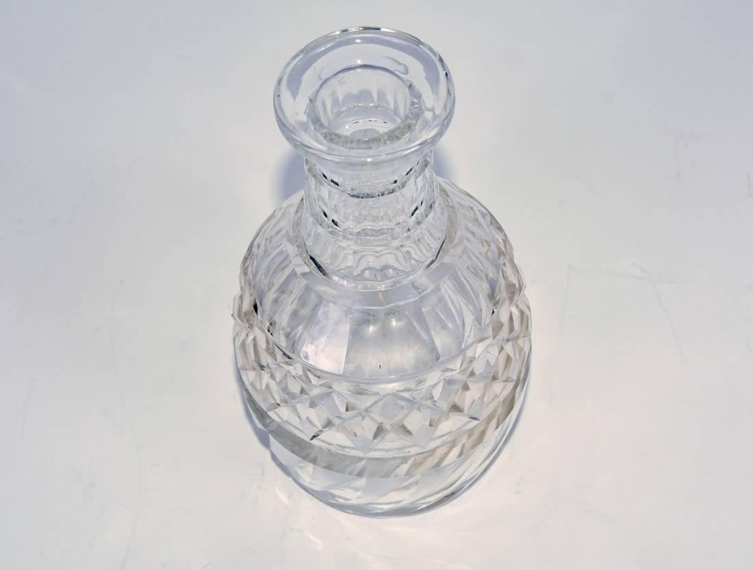 The 19th century English cut-crystal decanter has a variety of designs including repeated diamond and leaf-like patterns. The neck has rings for a secure grip.
OFFERING FREE SHIPPING WITHIN US CONTINENT.  JUST ASK FOR SHIPPING QUOTE.