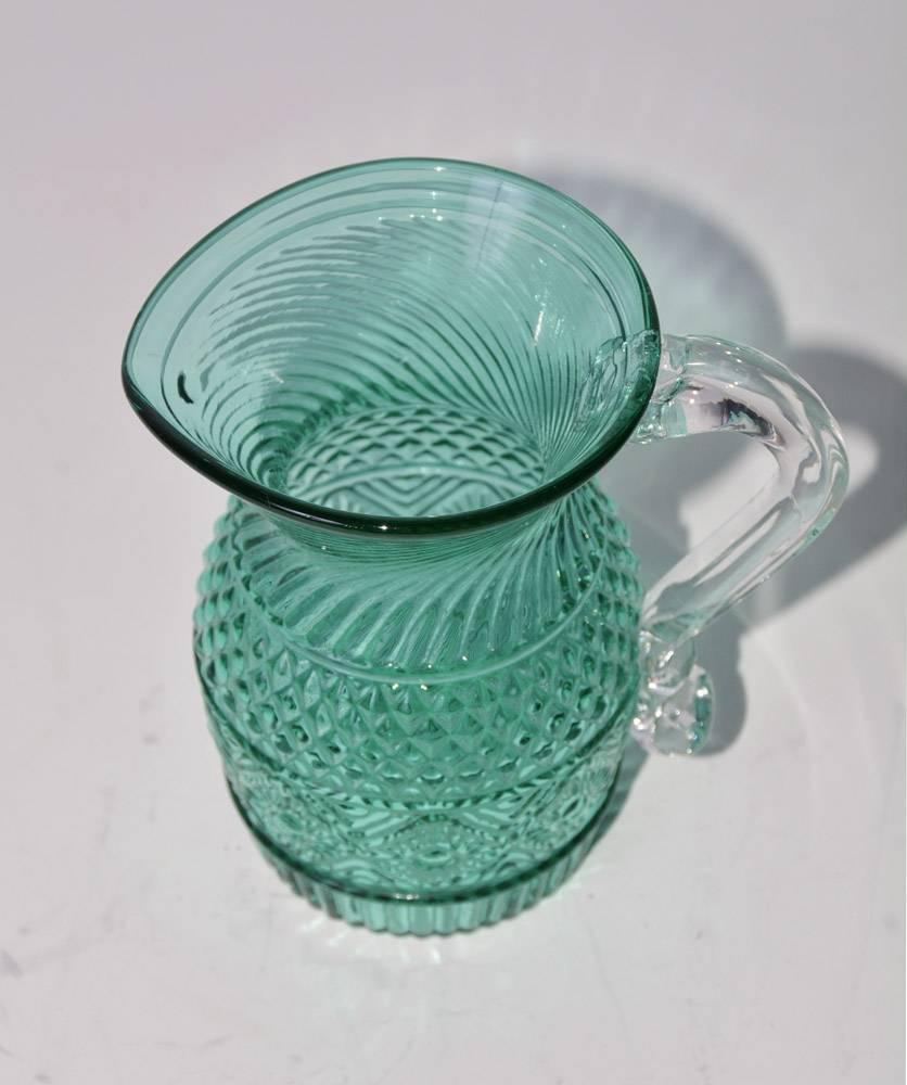 Petite Pair point blown glass creamers, light green Historic Jamestown blown glass Colonial style creamer. The small vintage handblown and pressed glass pitcher has a blue green body and clear handle. The design is a replica of early American