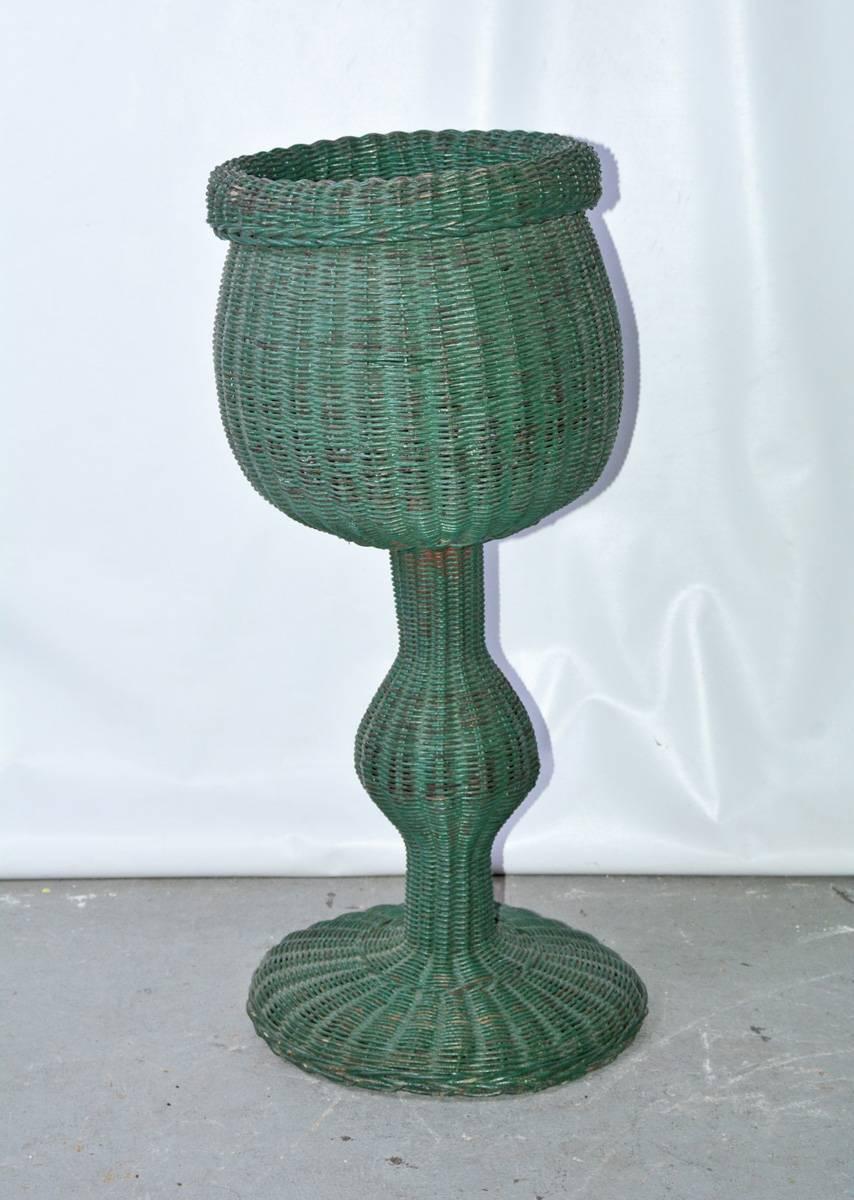 Woven wicker or rattan basket on stand.