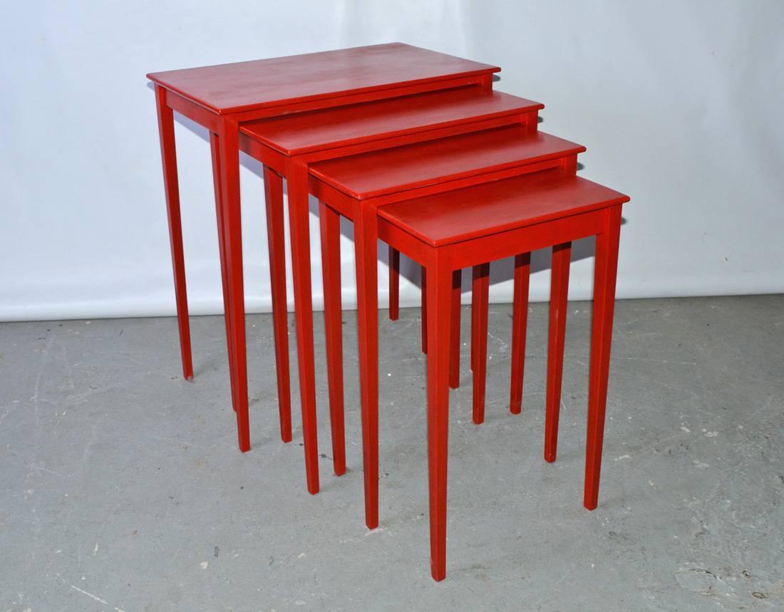 The vintage four-piece nesting tables slide underneath each other, have tapered legs and are painted in Chinese red lacquer.

Second table - D 15