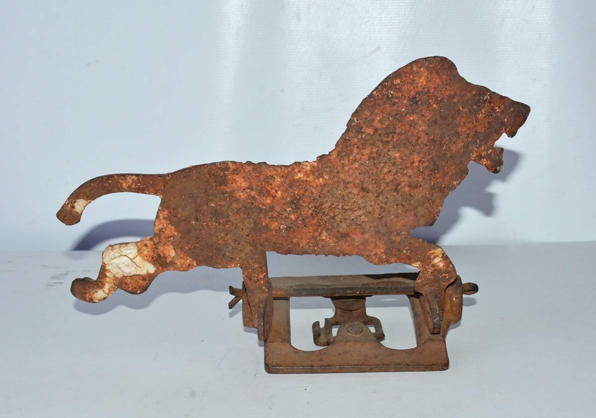 Rare antique cast iron shooting gallery target in the shape of a lion still attach to the base that supports the lion when a shooter knocks it over.  Wonderfully charming!  Great to display as a sculpture.