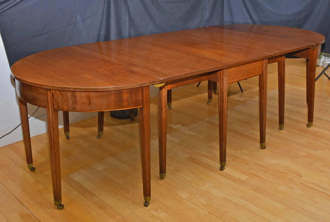 Versatile, Chippendale mahogany drop leaf table with Marlborough style legs that opens up to seat four, seating up to eight with two D ends.
Table has four central fixed legs and two mid-side pull-out legs that support the drop sides. D ends attach