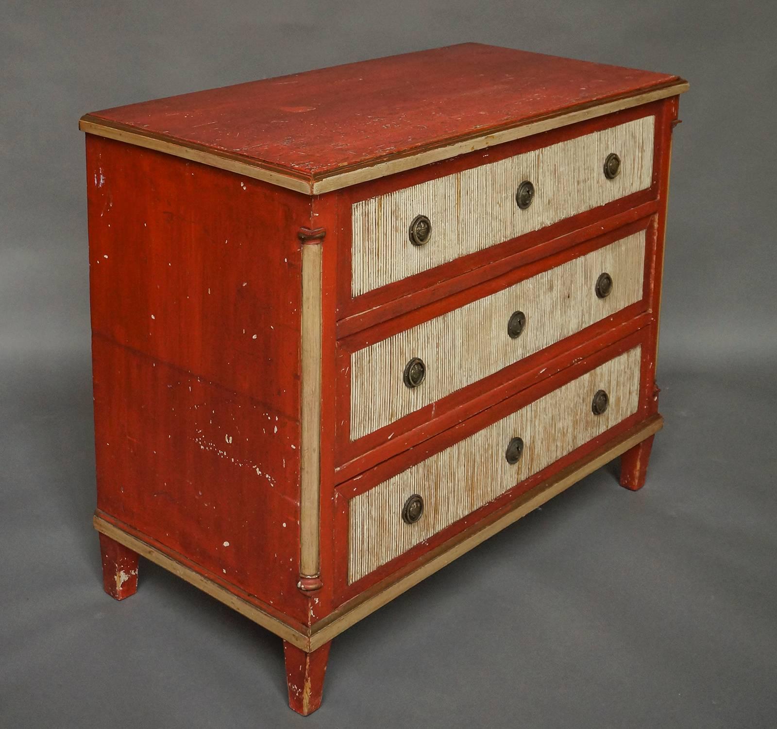 Chest of three drawers, perhaps Danish, from the neoclassical period, circa 1820, with original brass hardware and old painted surface. The drawer fronts have vertically reeded panels, and the chest corners feature quarter-round columns with simple