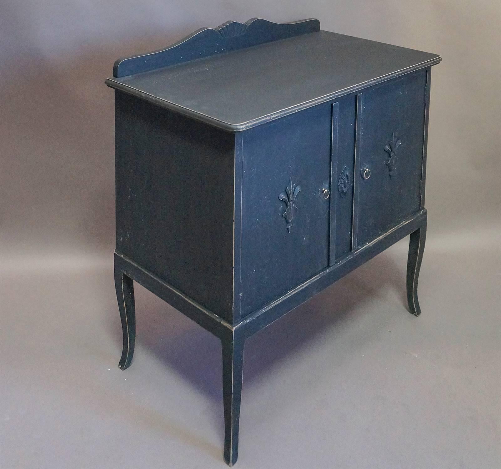Small storage cabinet in black paint, Denmark circa 1860, with two doors and two interior shelves.