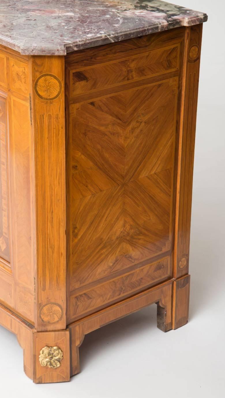 A fine Louis XVI marquetry inlaid bronze mounted
Marble-top cabinet.
By Jacob Kaufman Maitre, 1770.

Measures: Height 38 in, width 65 in, depth 22 in.

With a shaped rectangular marble top over two cupboard doors opening to a shelfed interior
all