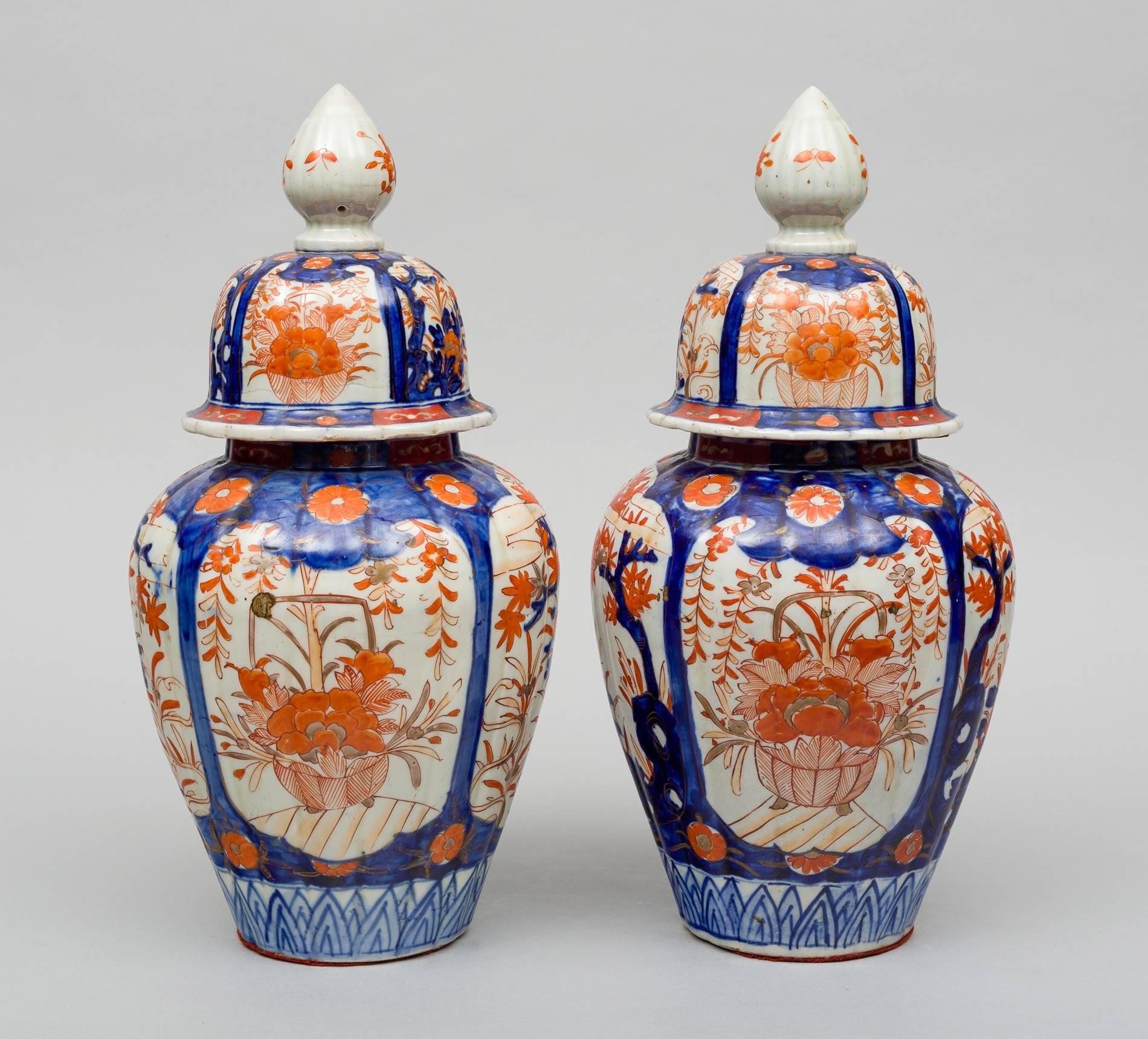 Large pair of Japanese Imari ribbed vases and lids, decorated in iron reds and cobalt blues, the body with four shield-shapes enclosing trees and flowers, the lids with large finials, circa 1890.

 


 