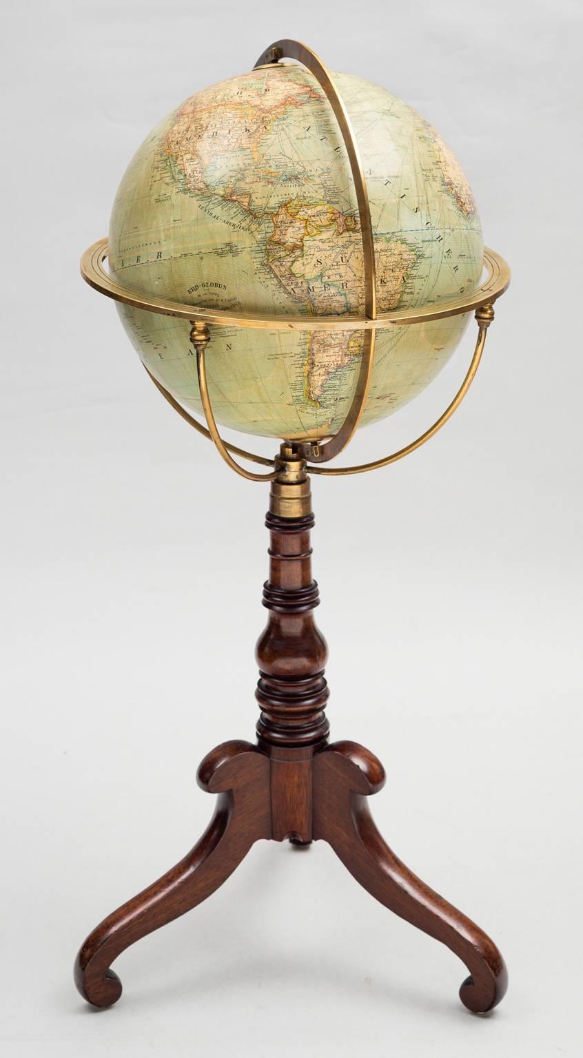 A German 12? terrestrial library globe by Wagner & Debes, Lehrm-Anst, of Leipzig on a mahogany tripod base with baluster vase turned pedestal on inwardly scrolled feet, the stand with brass quadriform cradle and brass meridian. Globe shows shipping