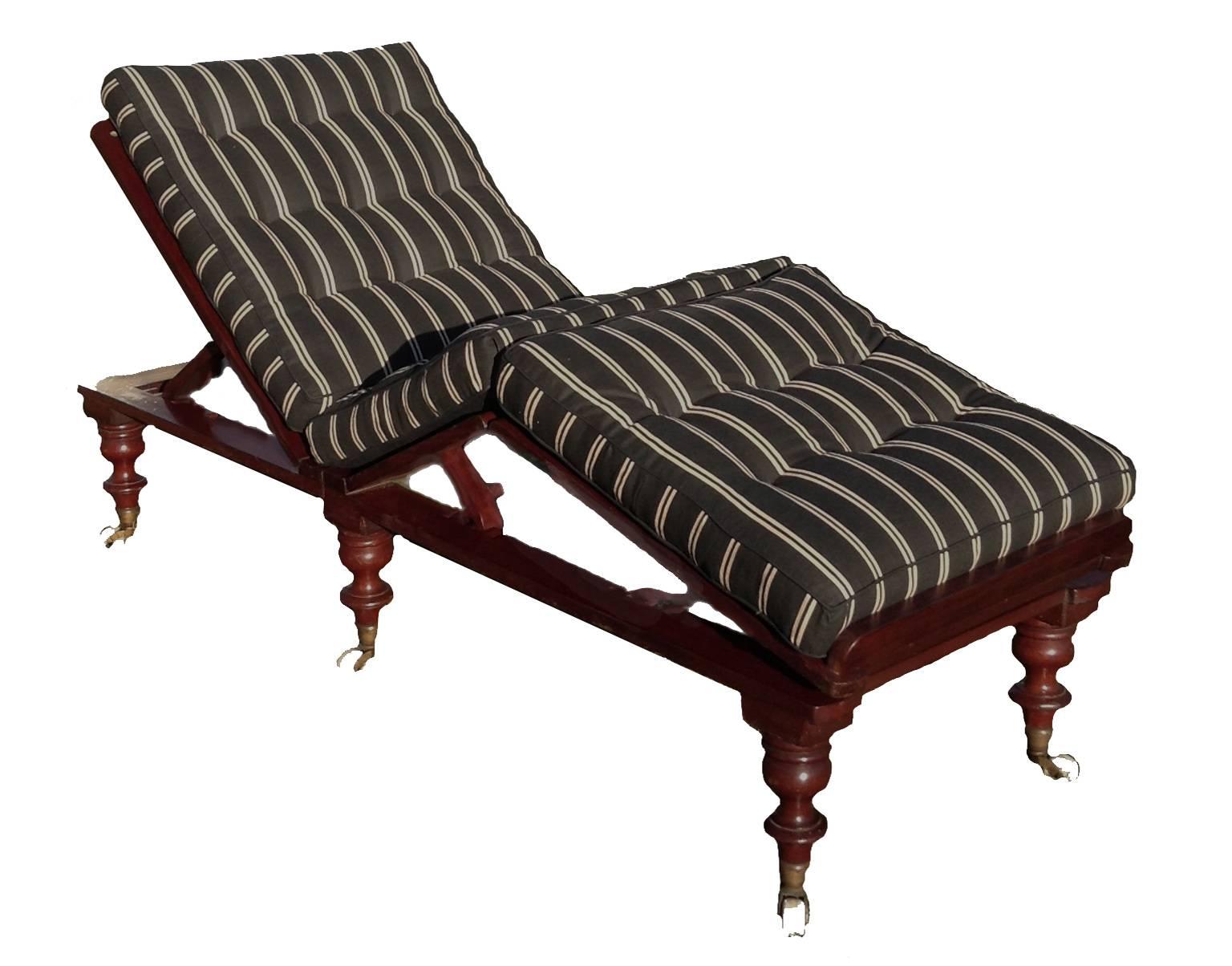 Mahogany caned, folding and fully adjustable daybed with removable legs and porcelain casters. Folds up for travel and goes completely flat for a daybed or couch. It has three sections each with a ratchet support for different back and knee