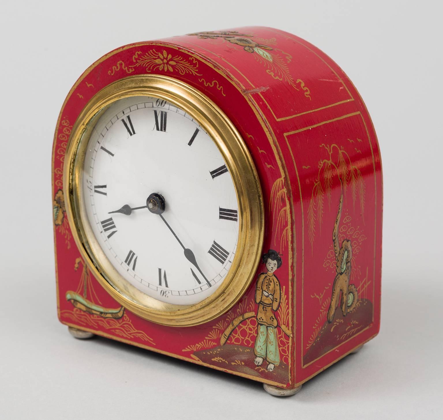 English red Chinoiserie 8-day desk clock in a dome shape, the dial with Roman numerals, the front bottom decorated with a young lady and a boat upon the sea, the sides with a pagoda and trees. The inside back marked Rotherham, Made in England,