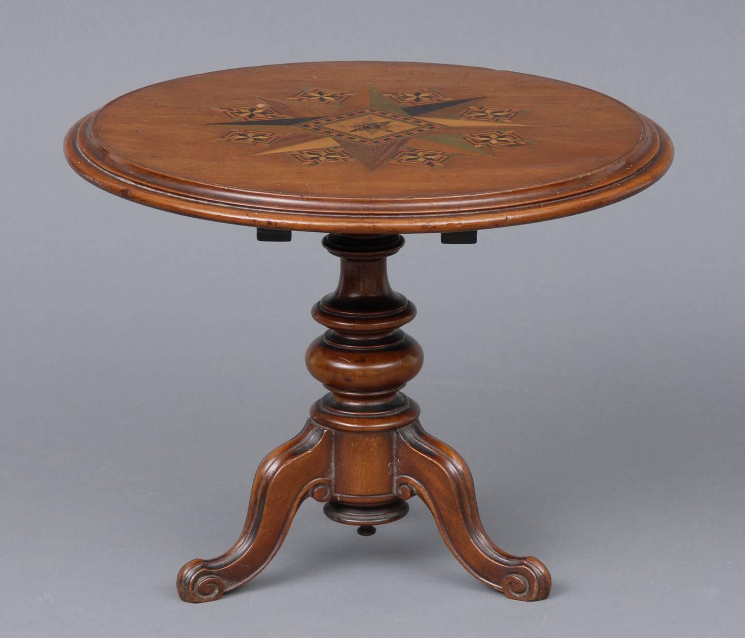 Miniature Victorian Tunbridge ware mahogany tilt-top table inlaid with an eight point star mosaic, on bulbous turned pedestal on molded tripod base ending in scroll feet. Item #6685.