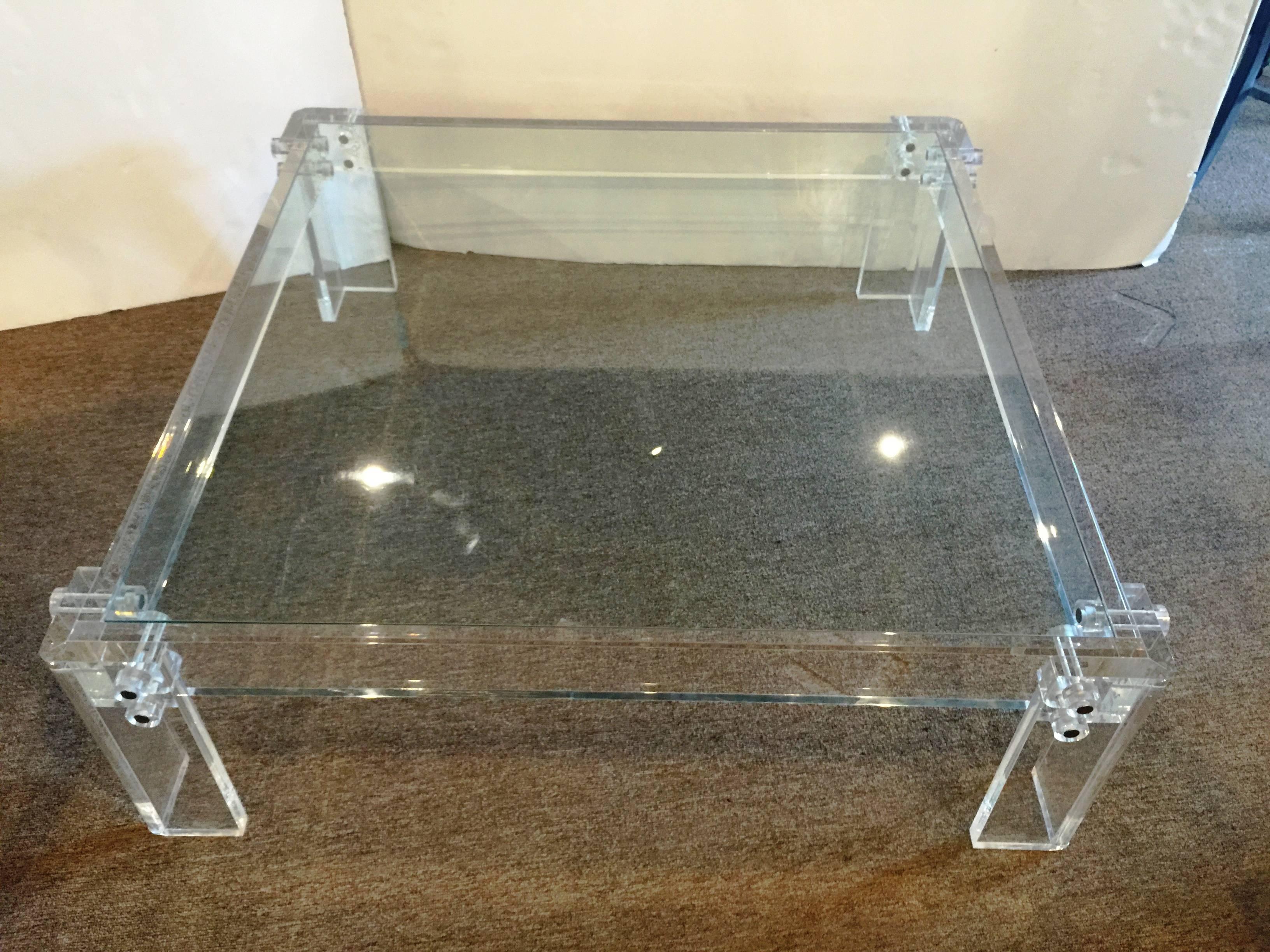 A fabulous coffee table with inset square glass top and large thick clear acrylic frames.
 