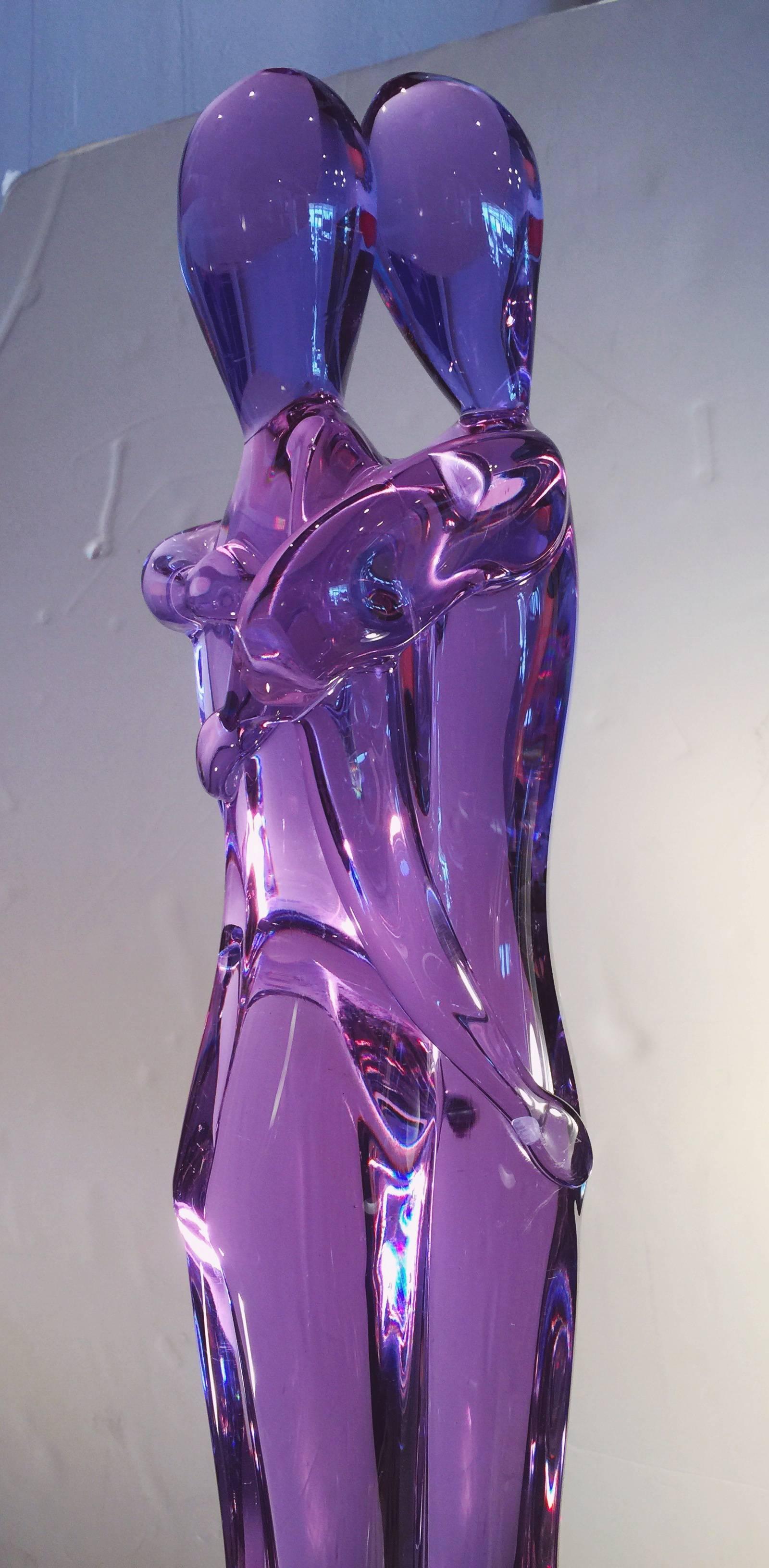 “The Nude Lovers” is a beautiful vintage Murano sculpture made using “Alexandrite Neodymium glass” which has stunning variation colors from Amethyst, to blue color and pink under the spotlight. 
Well sculpted, attached on a heavy rectangular glass