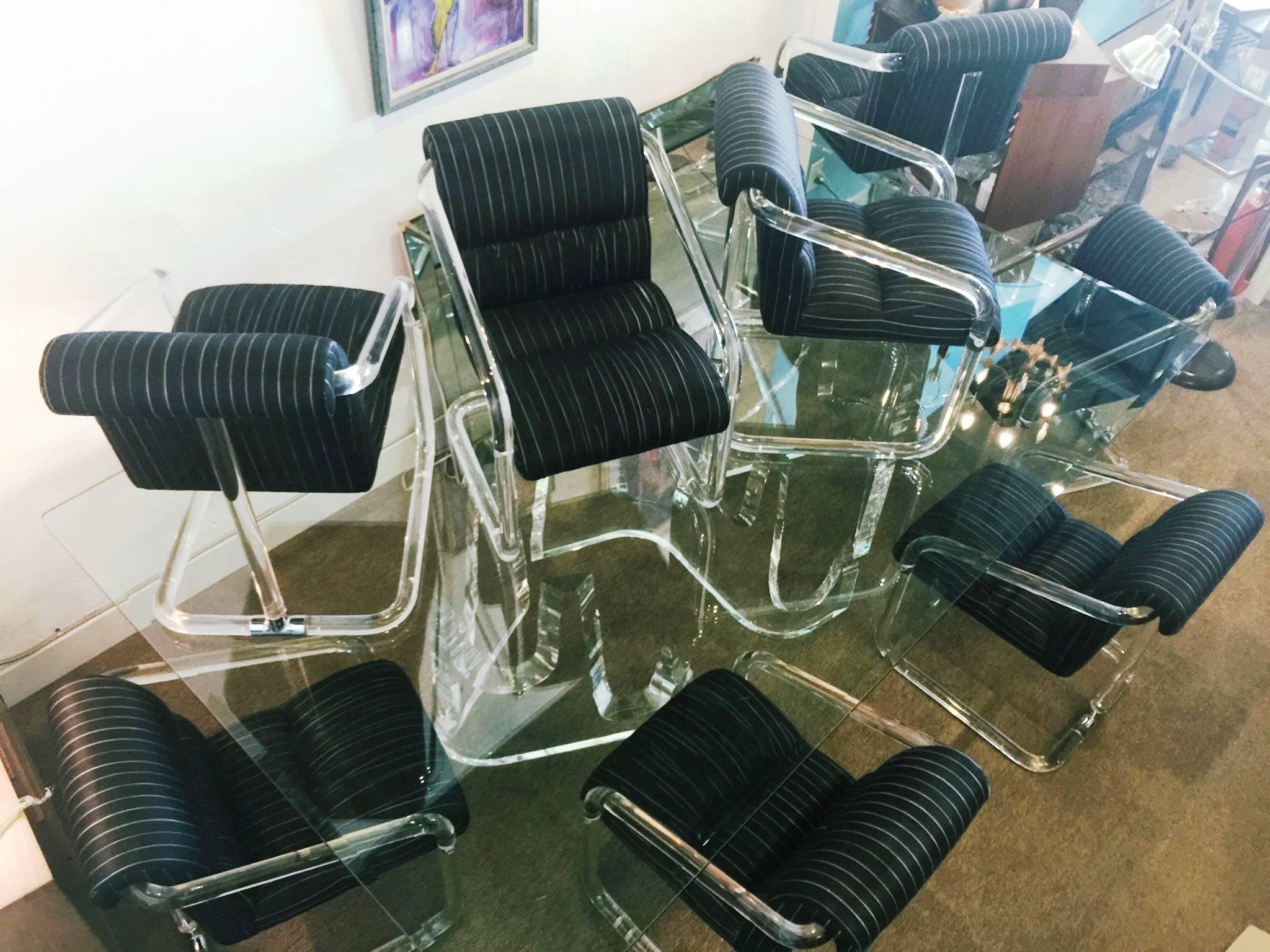 A timeless set of eight very comfortable armchairs in thick molded tubular Lucite with chrome fittings. Each base is signed on the bottom by Lion in Frost. The fabric (silk) is original. Wear consistent with age and use (circa the 1970s). For two of
