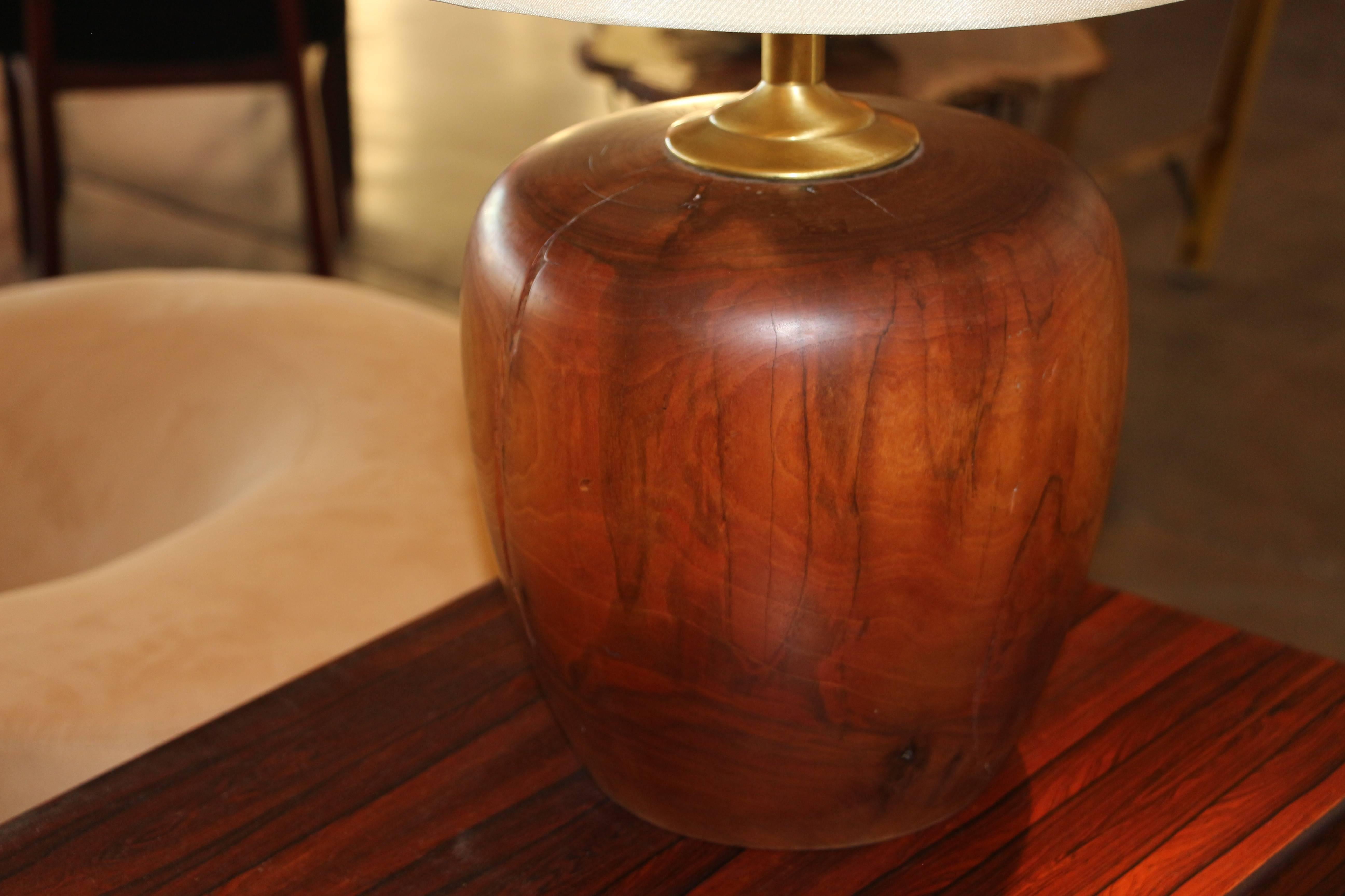 A extremely heavy turned wood base turned into a lamp. Nice patina to the wood and great cracking and character to the lamp. Wood part alone is 11 inches tall and 10 inches in diameter. The cord shows it's age maybe 1960s-1970s.