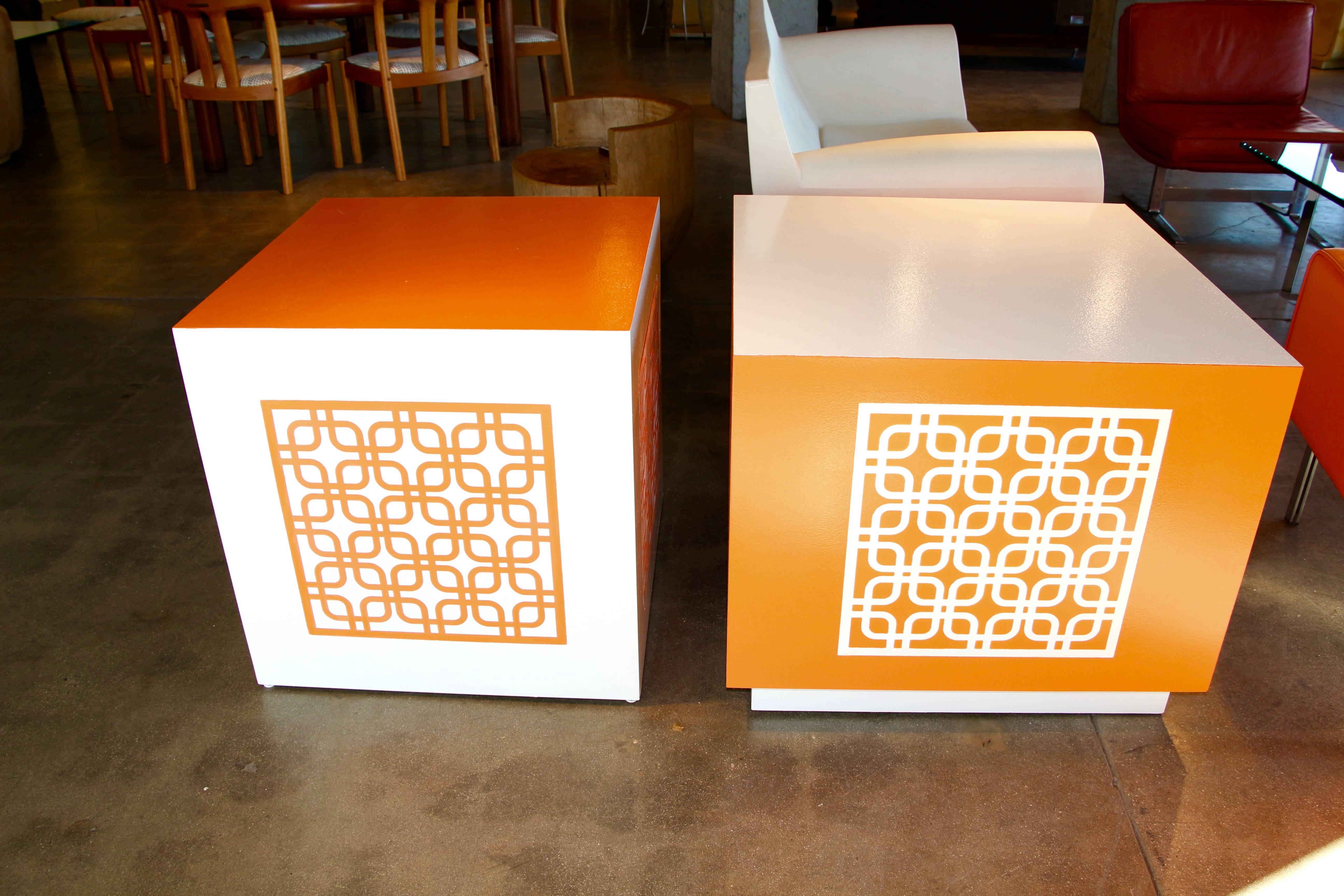 A great looking pair of end tables or cubes re-painted by a local palm springs artist. One table is slightly larger than the other and has a base. The smaller one 24 inches cubed. larger one dimensions are given below. Both are the same