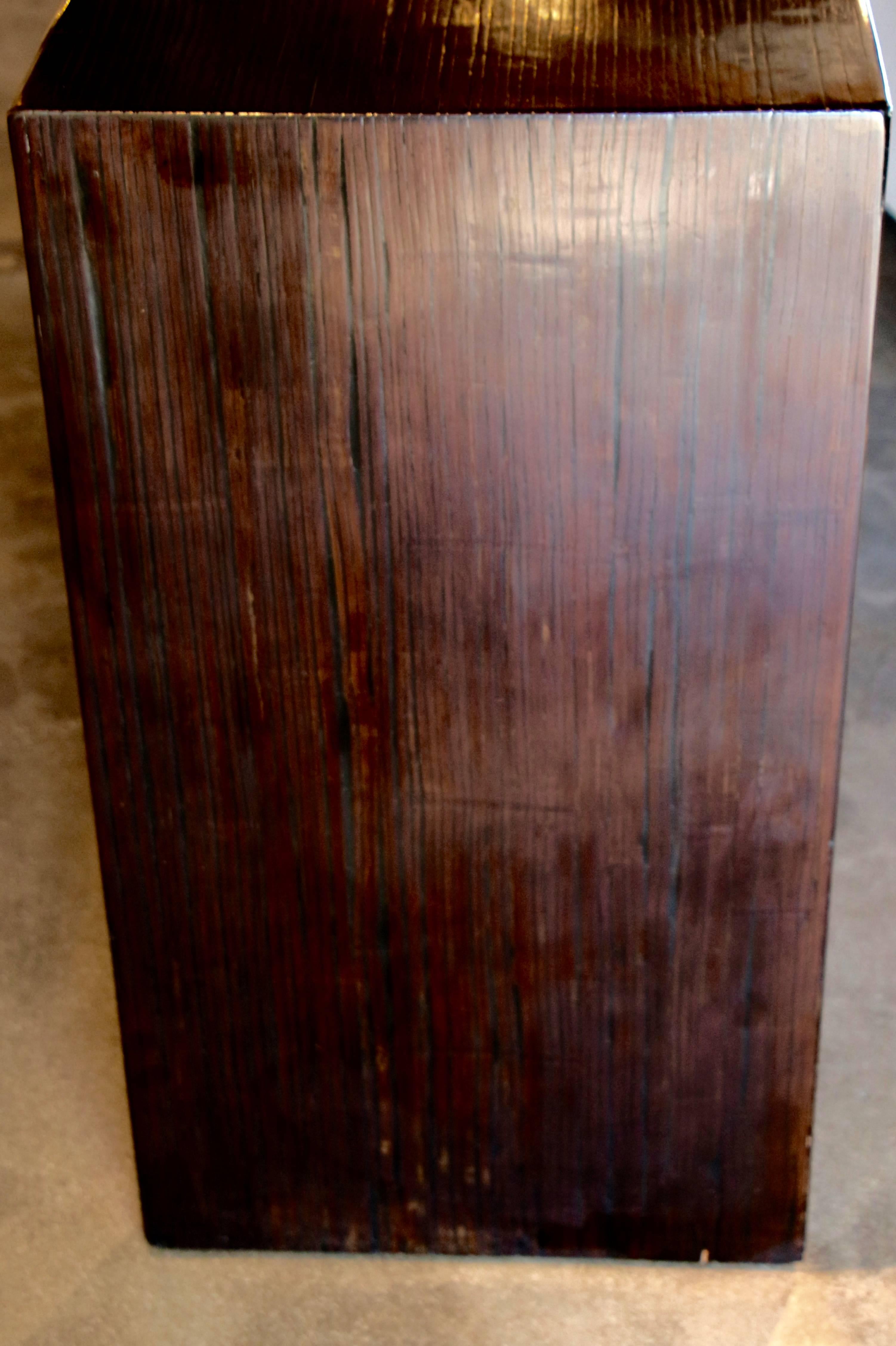 A beautifully grained brown console. I'm not really sure what kind of wood it is, it is possible bamboo veneered and Asian, except to say how lovely the grain is.