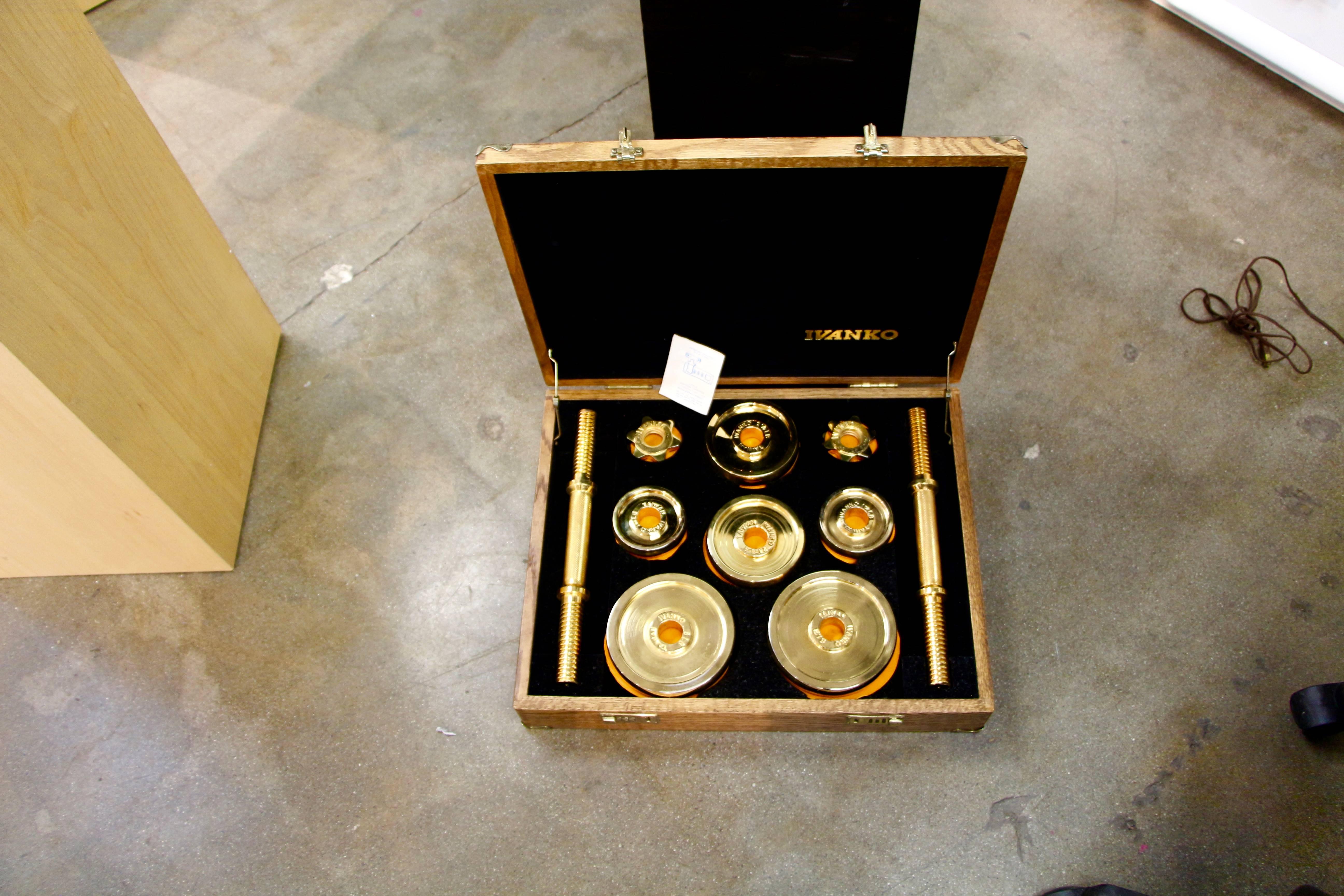 A limited edited Ivanko weight set plated in 22-karat gold made in a limited run in the early 1980s. There are four 5-pound weights, four 2.5-pound weights, four 1.25-pound weights, holders and barbells. The box is in nice condition, with some minor