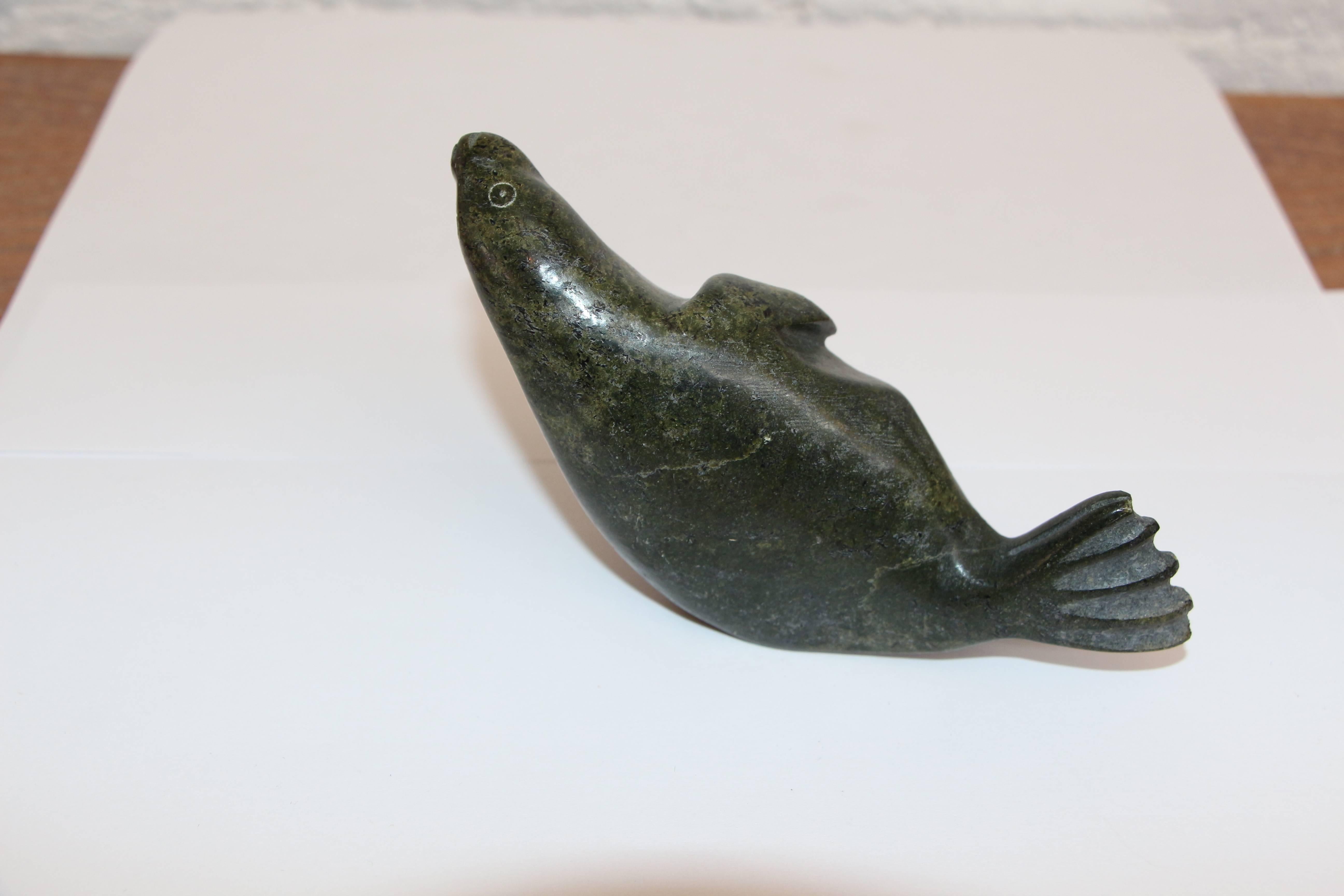 A nice duet of Eskimo or Inuit carvings of a walrus and a seal. They appear to be hardstone carvings. nice form and detail. The dark one is signed N Noah, and is approximately 5 inches long 1.5 inches deep and 3 inches tall. Size given is for the