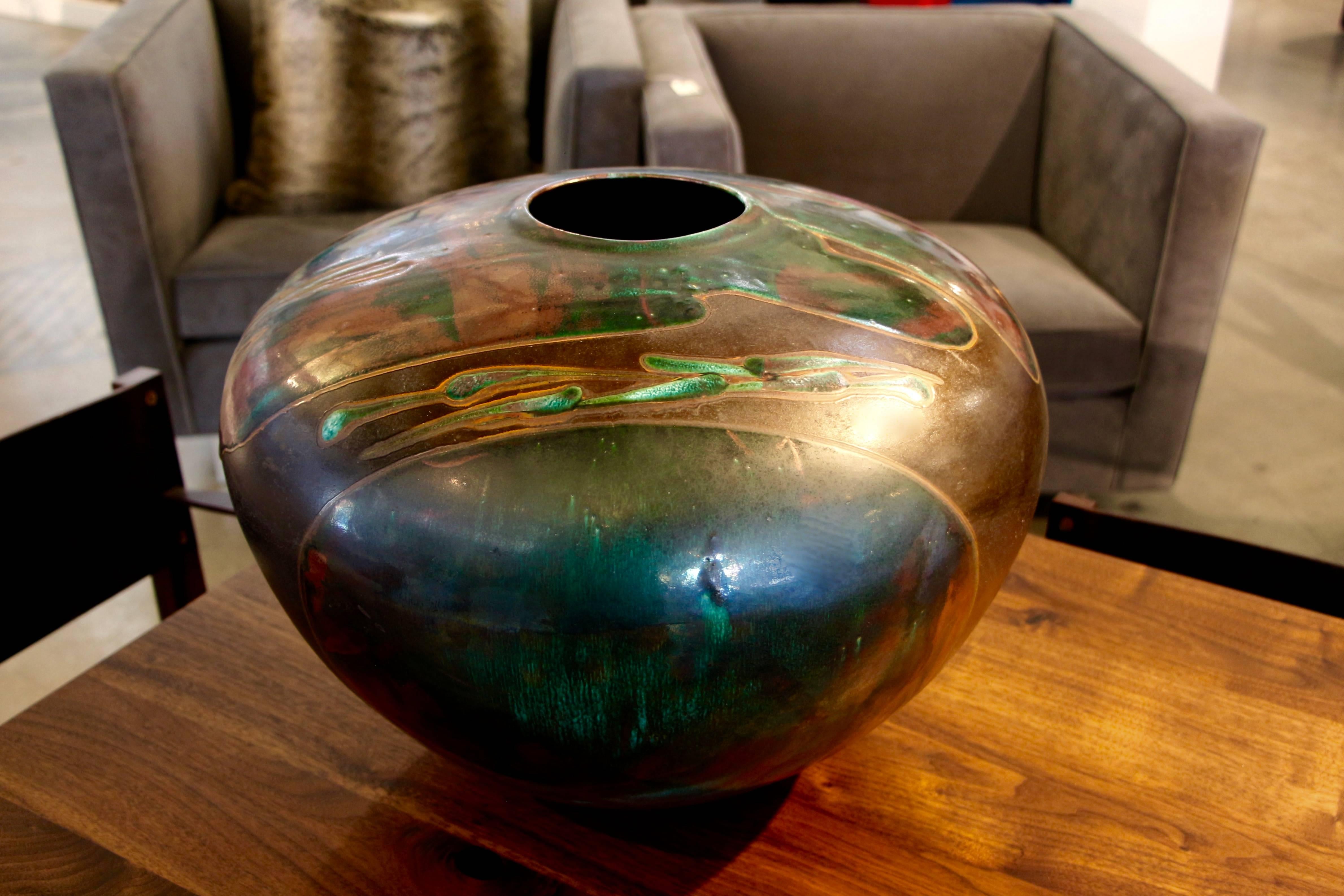 A signed Tony Evans of Evans Studios in California monumental raku fired centerpiece. Very typical colors, as his 1980s pieces were all in pink hues. This is one impressive piece of pottery.