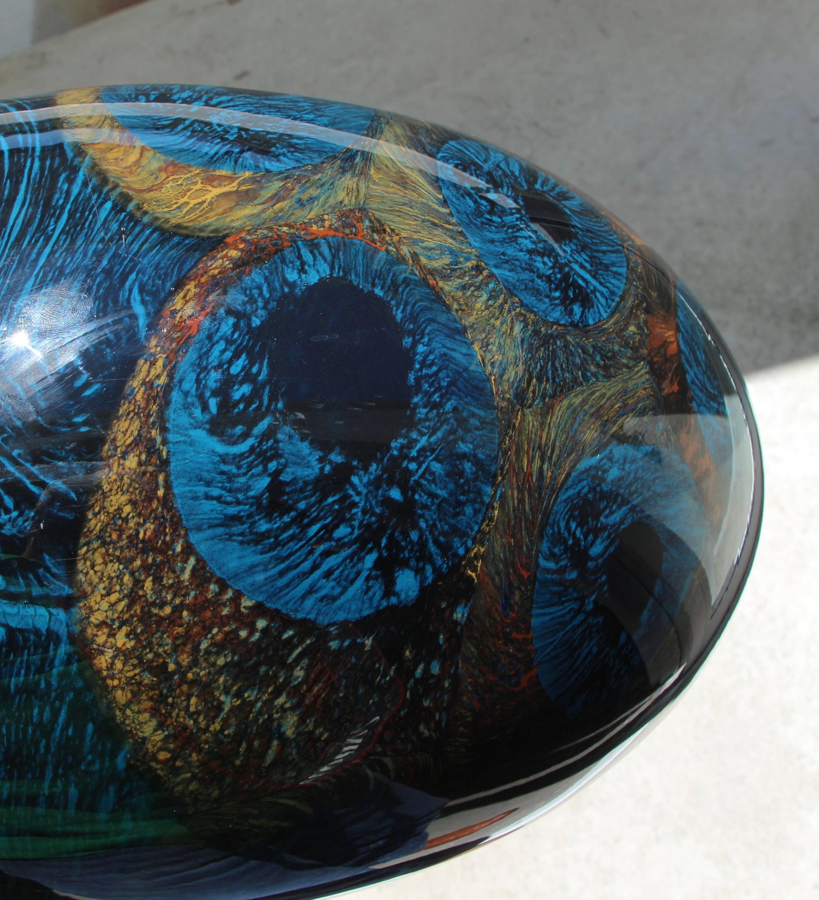 A quite lovely piece of art glass that is illegibly signed. It has amazing color when the sun hits it, or a spotlight. There is a scratched to an area near the base, which is pictured.