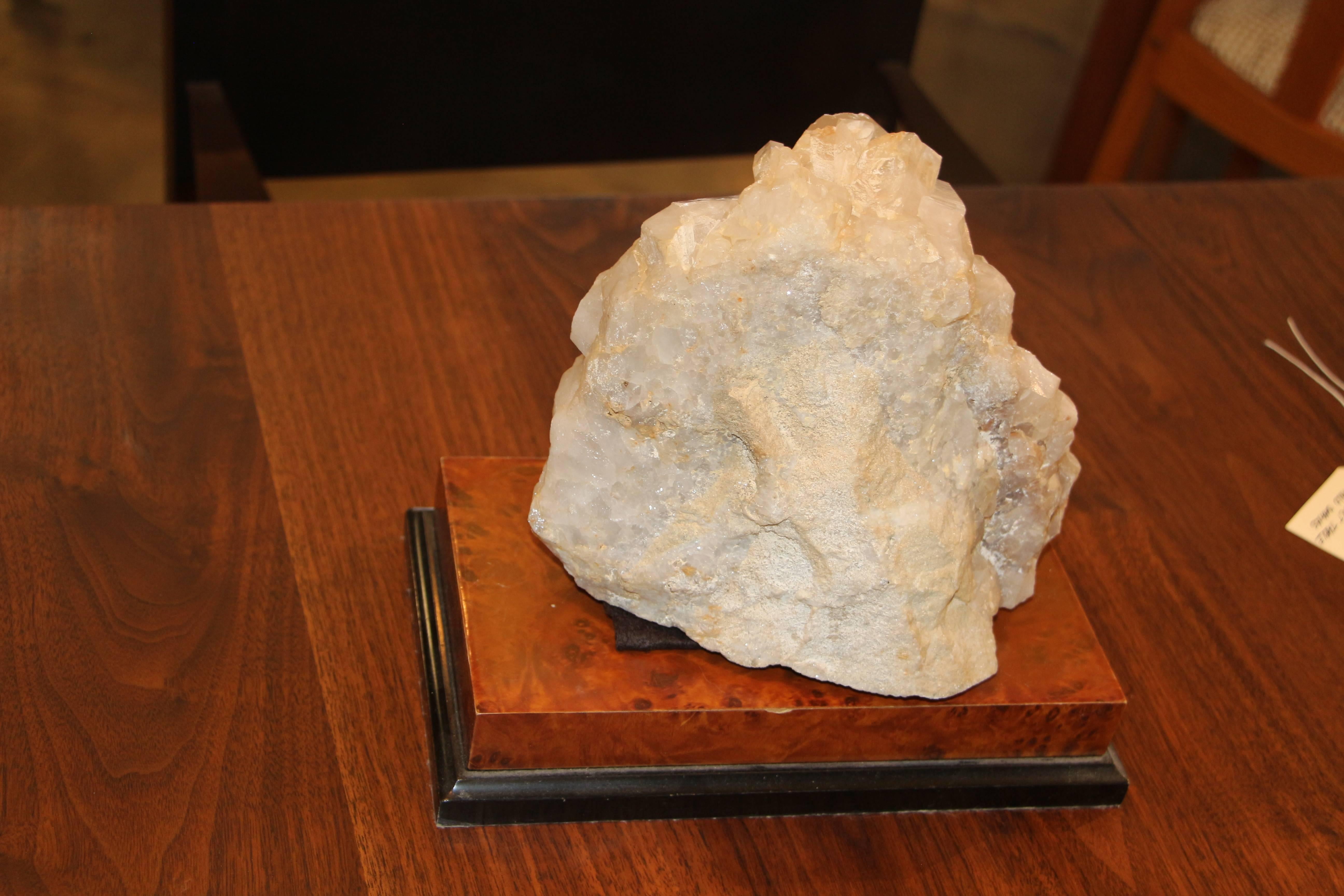 A nice large quartz crystal specimen sitting on a wood base that looks like it’s covered in leather and painted black. The pieces are separate and I have put a piece of felt of the base of the quartz to protect the base. The actual dimensions of the
