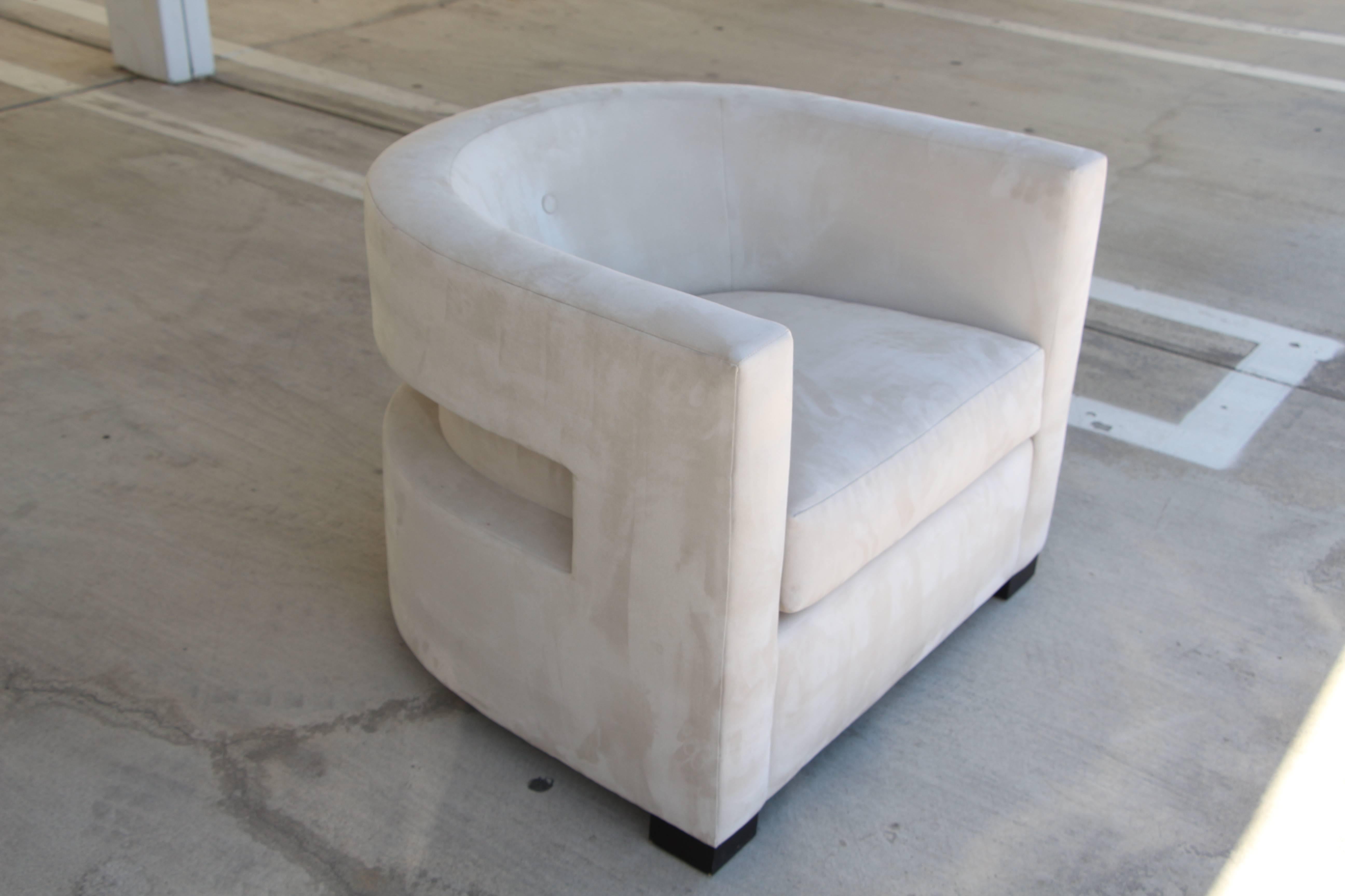 A most unusual club or lounge chair in a micro fiber or ultrasuede fabric. It is quite a lovely chair. It bears the label of a defunct high end west coast furniture store. Don't know who designed this piece but it is quite stunning and comfortable.
