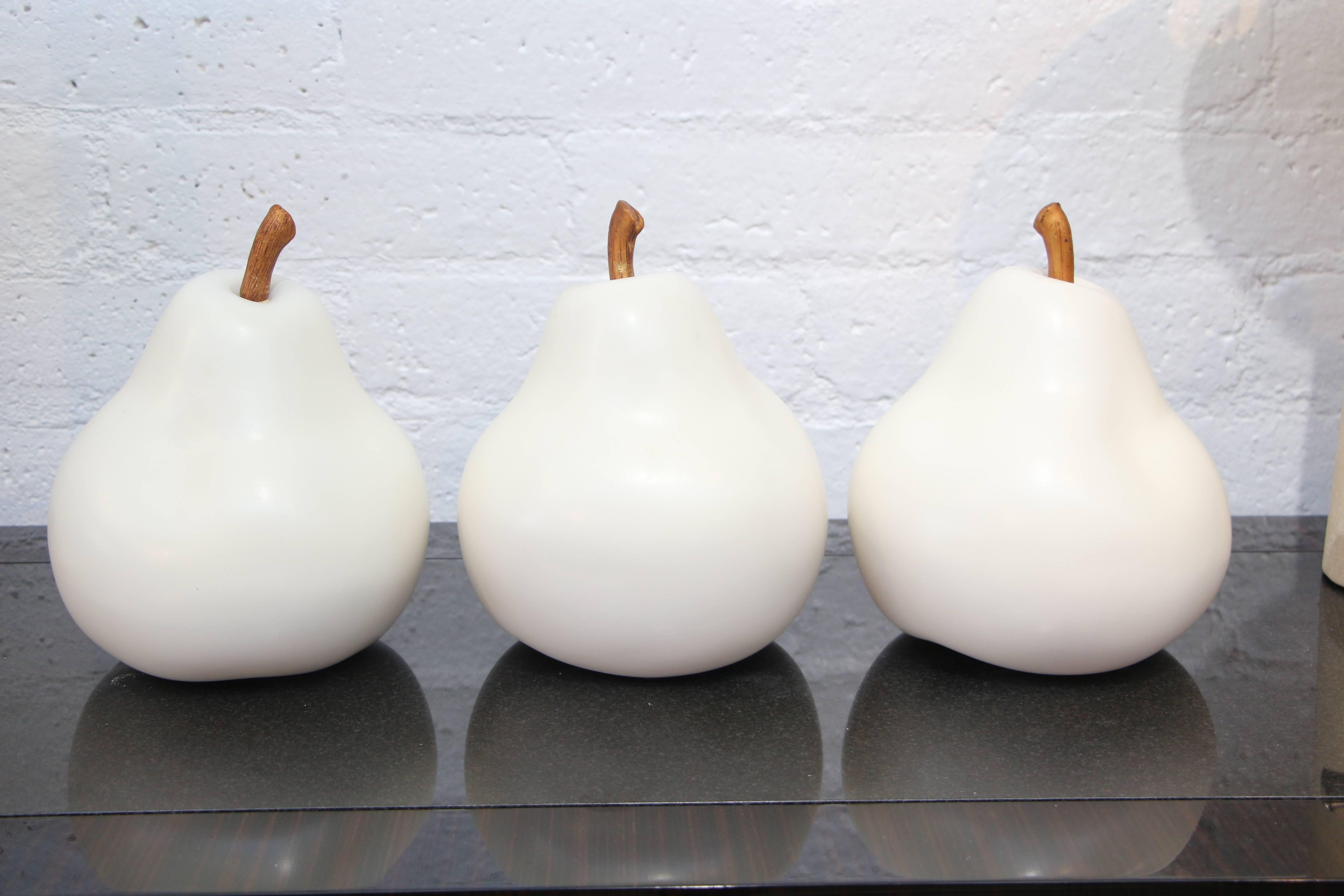 Three great ceramic pears. We have had this in quite a few sizes. The stems appear to have been glided at some point. Unique mark on base.