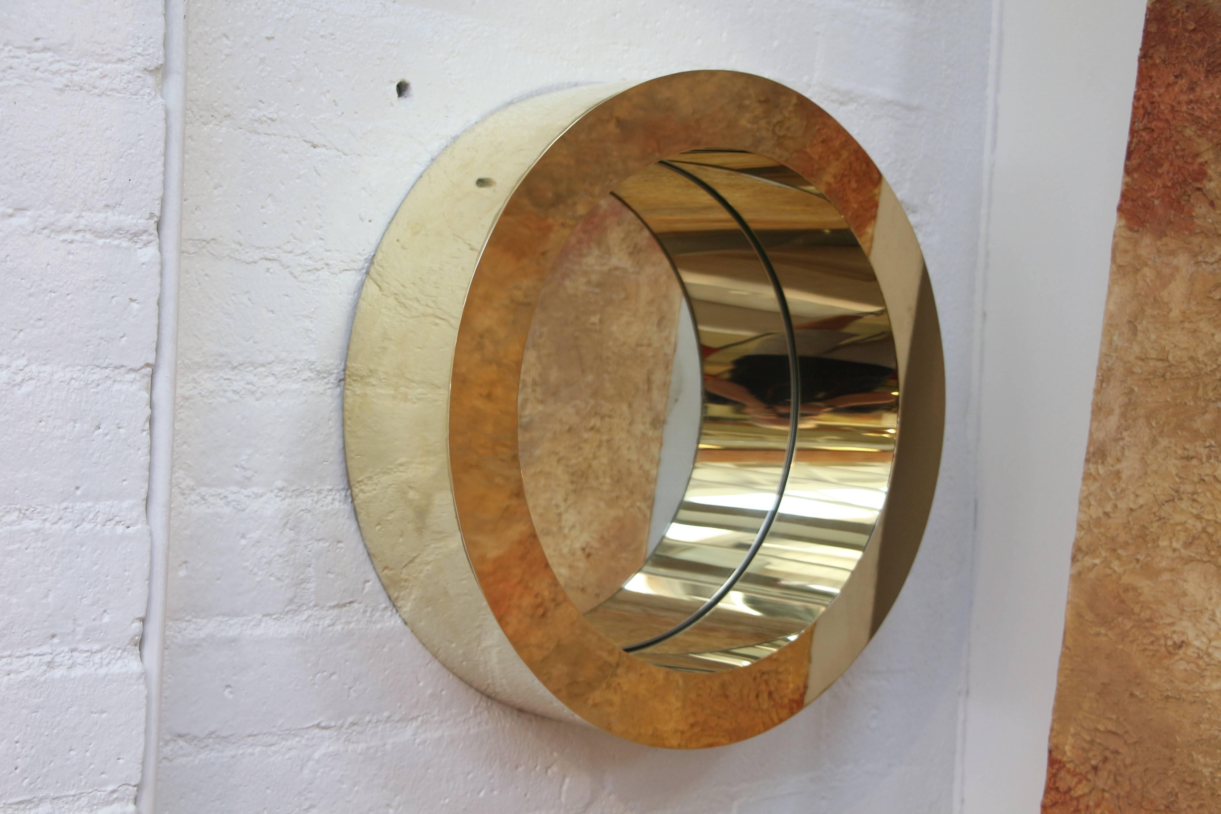 A nice porthole mirror from Curtis Jere. We have had it polished so the signature is lost. I should have taken a pic of it but forgot to. In nice condition, although there is a small ding and a ripple along the edges. There may be some other marks