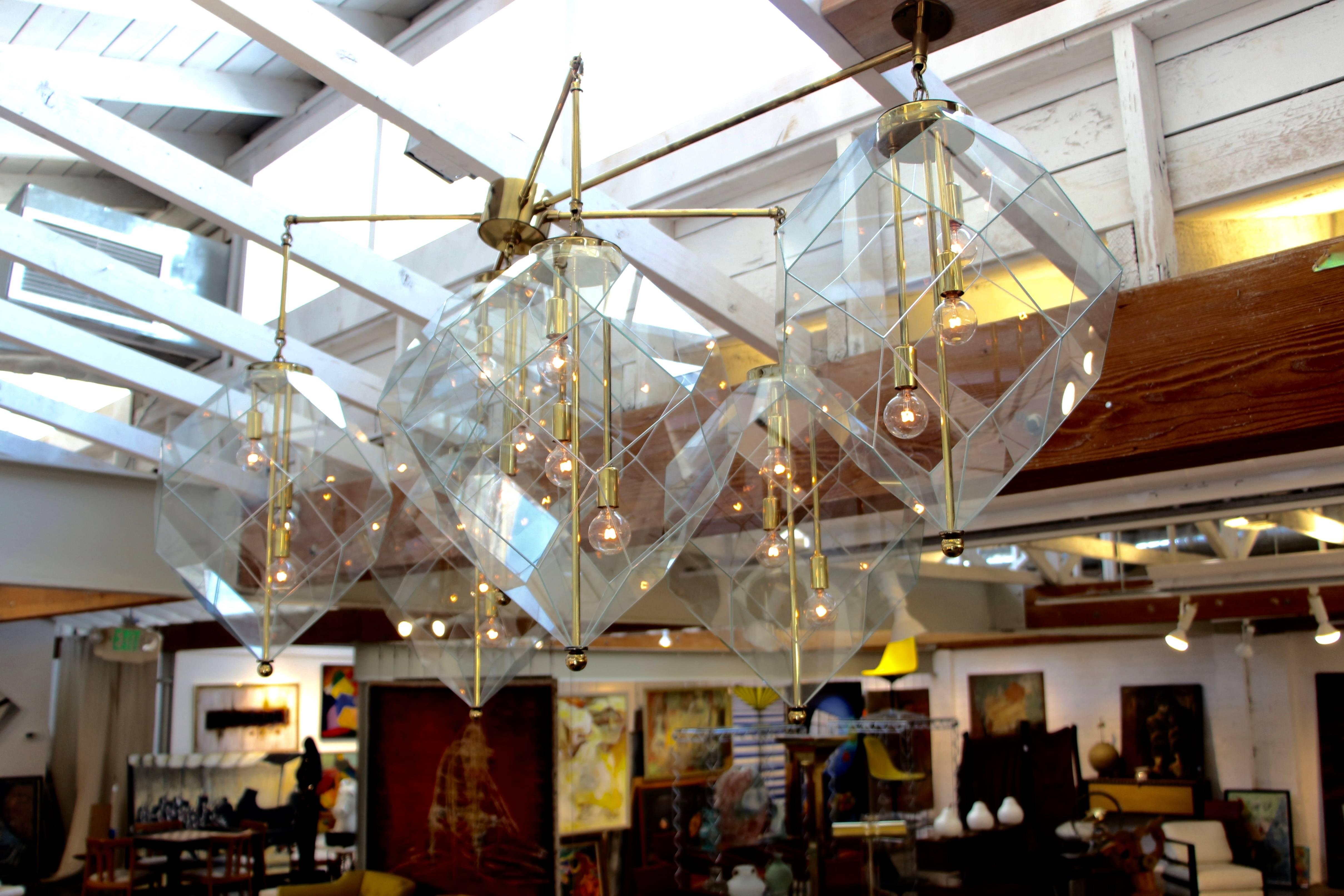 A monumental custom-made chandelier ordered in 1978 from the Morrison Lighting company. This is a pretty monumental fixture with faceted glass shades and long brass arms. It dims and shows beautifully. This fixture was made by the Morrison lighting